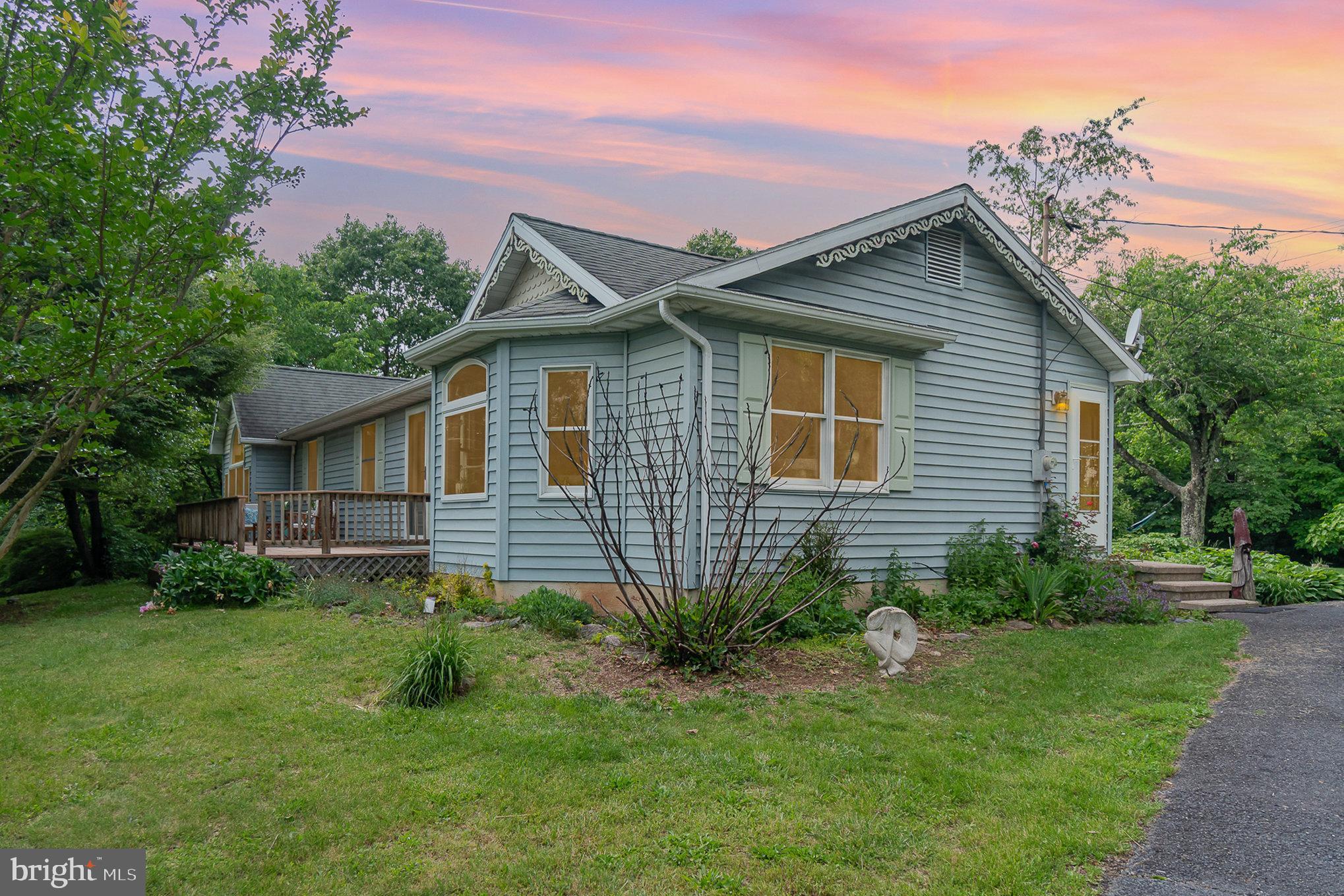 3 Bedroom Rancher on 1.10 acres with the views & seclusion you've been looking for! Kitchen/Dining Area was remodeled in 2018- featuring Kraftmaid cabinets, stainless steel appliances, beautiful waterproof floors, and glass tile backsplash. New HVAC system in 2020, new washer/dryer in 2024, new water heater 2025. Bathroom was remodeled in 2021 with gorgeous tile shower. Half bath has plenty of room to add a shower or tub to make it a full bath. Original hardwood floors in living room & hallway. Stunning real wood doors & trim throughout! Large master bedroom with attached dressing room- you'll feel like you're sleeping among the trees- no need for curtains with views & seclusion like this! Office could also be a 4th bedroom if needed. Full unfinished basement offers endless possibilities for storage, hobbies, or more living space! Large front & back porches have been freshly stained and are perfect for relaxing or entertaining.
