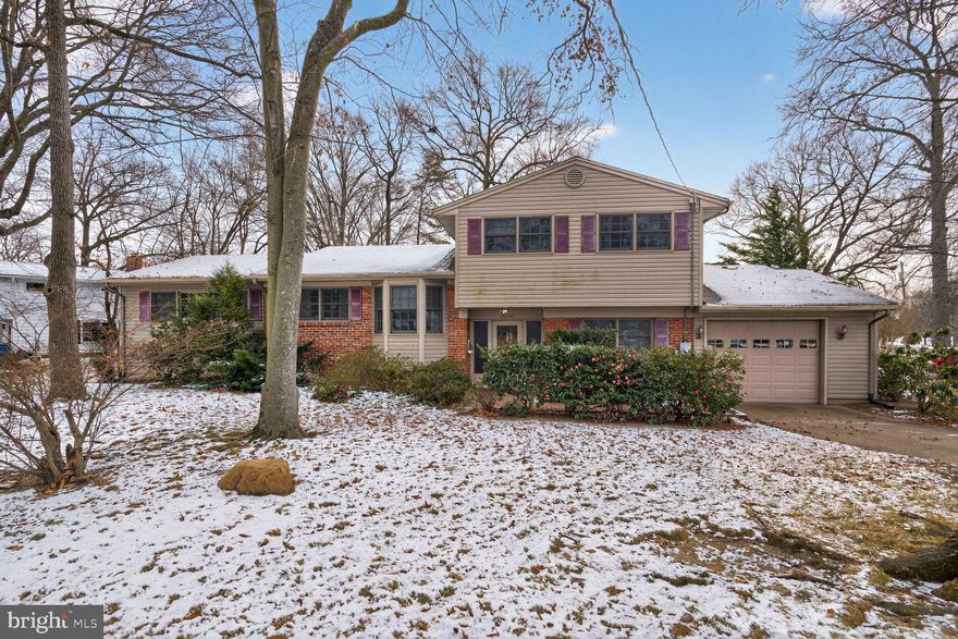 Welcome to 3000 Battersea Lane, a lovely split-level sited on over a quarter-acre lot with a garage in Mount Vernon’s desirable Riverside Estates. This terrific 4-bedroom home has an expansive front yard and a charming brick path leading up to the front door. As you enter, you are greeted by a large foyer next to the roomy laundry and utility room, which offer plenty of additional storage space. The charming rec room features a cozy fireplace with a brick surround and classic wood mantel—ideal for those winter evenings. From here, you can step out onto the back deck in the fully fenced backyard and enjoy hot summer days grilling beside the in-ground swimming pool. Back inside, enjoy the spacious living room and the view from the large window that spans the width of the wall and brings in a ton of natural light. The dining room has hardwood floors & the kitchen has a big bay window that makes it light & bright. There are four generously sized bedrooms, including two primary rooms, all equipped with ceiling fans. The owner’s suite addition is on the main level and has multiple windows, a big walk-in closet with built-in shelving, and an updated en-suite bathroom with a deep soaking tub. A few steps down is the appealing sunroom with a soaring vaulted ceiling surrounded by windows—a perfect place to soak in the sunshine by the pool. On the third level, you’ll find the other three bedrooms and two full baths, including another primary bedroom with its own en-suite bathroom. This home is within walking distance of the high school and located just minutes from Fort Belvoir, Old Town Alexandria, and only two miles from the George Washington Parkway for a scenic commute along the Potomac River to National Airport and Washington, D.C..Bring your imagination & favorite contractor and turn this into your dream home!