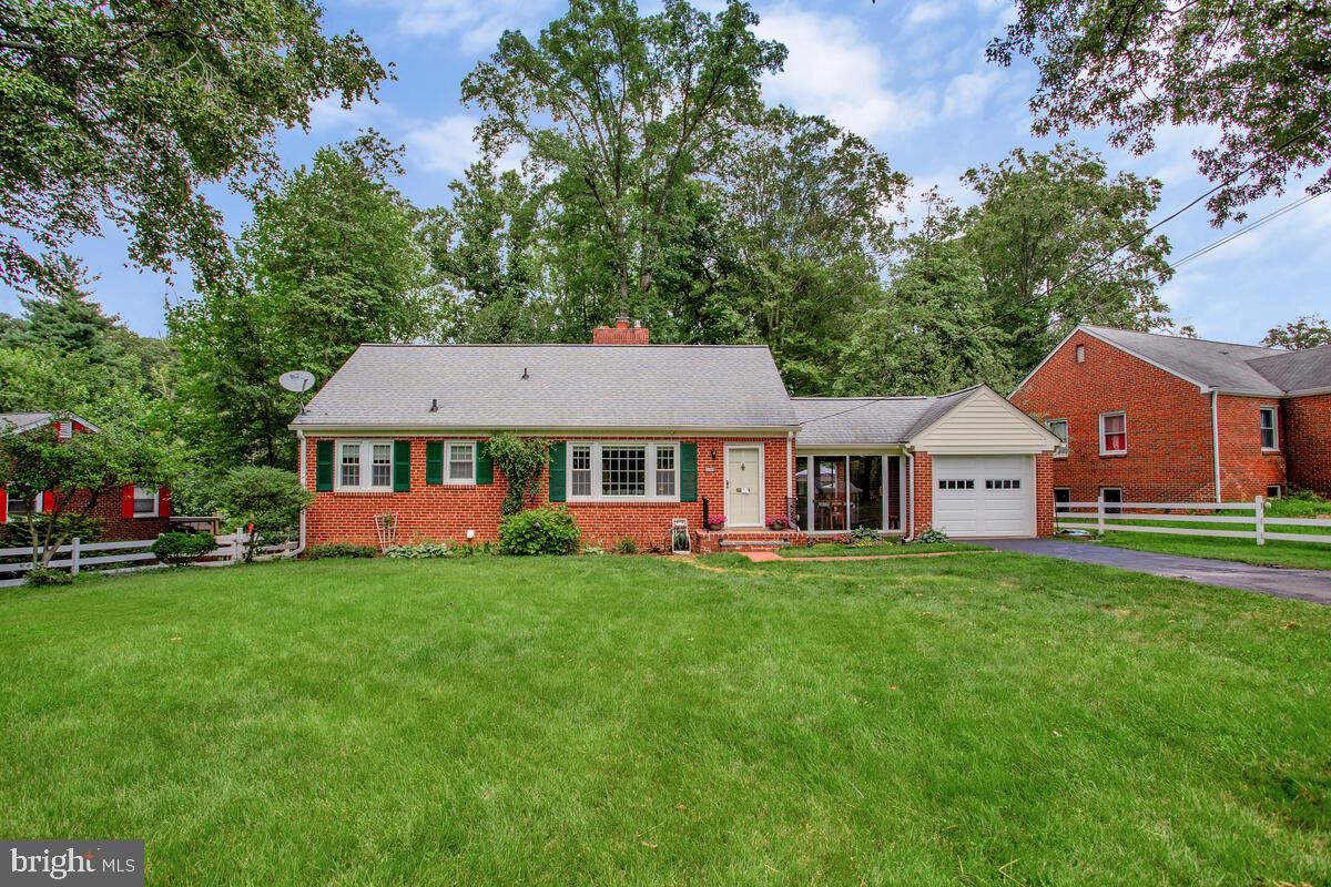 This thoughtfully updated and immaculately maintained rambler is ready for its new owner! The main living area features clean hardwood floors, bright windows that allow for abundant natural light, and a fireplace for cozy nights. The kitchen boasts a dual steel sink and an abundance of cabinetry. The dining room, with its built-in cabinet and glass doors, is a perfect backdrop for dinner parties. Two good-sized bedrooms and a full bath complete the main level. The partially finished basement includes a recreation room, a laundry/mechanical room, third bedroom, a full bathroom with a shower, and a rear walkout with a walk-up. The three-season room, perfect for quiet dinners or entertaining loved ones, backs to the fenced-in grounds. The exterior features a rear patio, gardens, and flower beds. Parking will be a non-issue with an expansive driveway and a rare-for-the-neighborhood one-car garage. Recent updates to the property include: New gas line, Two sump pumps, HVAC (2023), Gas water heater (2019), and Roof (2017).This home is located just minutes from shopping, dining, entertainment, and major highways. This one won't last long—schedule your showing today!