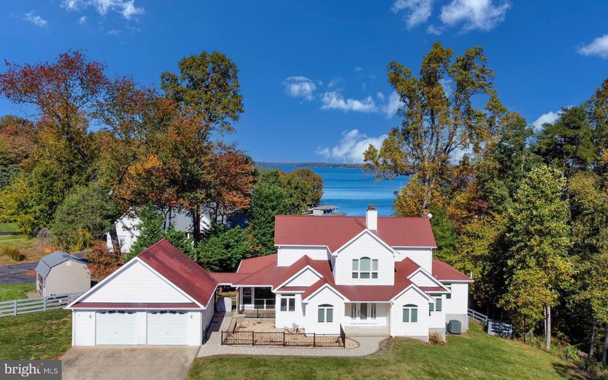 Welcome to your new dream home!  Situated on the enviable southern shores of Lake Anna's public side, this home has it all.  Zero-entry beach leads to your dock, boat lift, and everything the lake has to offer.  Perfect for launching kayaks, paddleboards, swimming, lounging, and boating.  On the other side of the property, you will find a full-sized pickleball court, basketball court, and large flat field - perfect for sports, ATV riding, horses, or possibly building future out-buildings.  You'll also find a massive barn with two oversized doors to store all your toys, watercraft, vehicles, lawn equipment, or animals. 

The main house is equally impressive, with nearly 5-mile views of the lake.  Take some time on the full-length covered back patio or screened-in porch to catch up on life.  The home was fully renovated and professionally designed in 2020 and you'll fall in love with everything it has to offer.  The brand new kitchen gives you unsurpassed views of both the grounds and lake.  You'll love the new flooring throughout.  After a long day, take some time in your new luxury master bathroom.  The main floor offers a large family room, kitchen, powder room, laundry room, bonus room/office, and pantry.  Upstairs, you'll find two oversized bedrooms and bathrooms, each with amazing lake views.  The lower level offers two living areas, a kitchenette and bar, each with unobstructed lake views, plus a private bedroom and full-size bathroom.  The lower-level also walks out onto an oversized slate patio offering even more outdoor space and lake views.   Indoor and outdoor furniture can convey for the right deal.