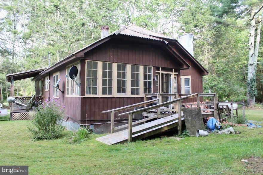 Rare opportunity to own a 1930's cabin situated on two acres in  Green Bank, with only a short distance to Snowshoe Mountain Resort (16 mi), Cass Scenic Railroad State Park (7.1 mi), and Green Bank Observatory and Science Center (1.7 mi.). Green Bank, WV is located within the National Radio Quiet Zone, is recognized as an area of low electromagnetic emissions and cellular radiation, and the Green Bank Observatory is home to the largest steerable radio telescope in the world. It is at the Green Bank Observatory, in 1961, that the Drake Equation was presented, which was developed to provide an estimate of the total number of detectable extraterrestrial civilizations in the Milky Way galaxy (per Wikipedia). The acreage includes beautiful creek frontage and plenty of gardening space.  The home is in need of extensive repair and will not qualify under FHA, USDA or VA financing.  Rehab loans or cash are ideal. No seller financing available.  Appointments are required to visit the property.  Do not enter the property without a Licensed WV Realtor.