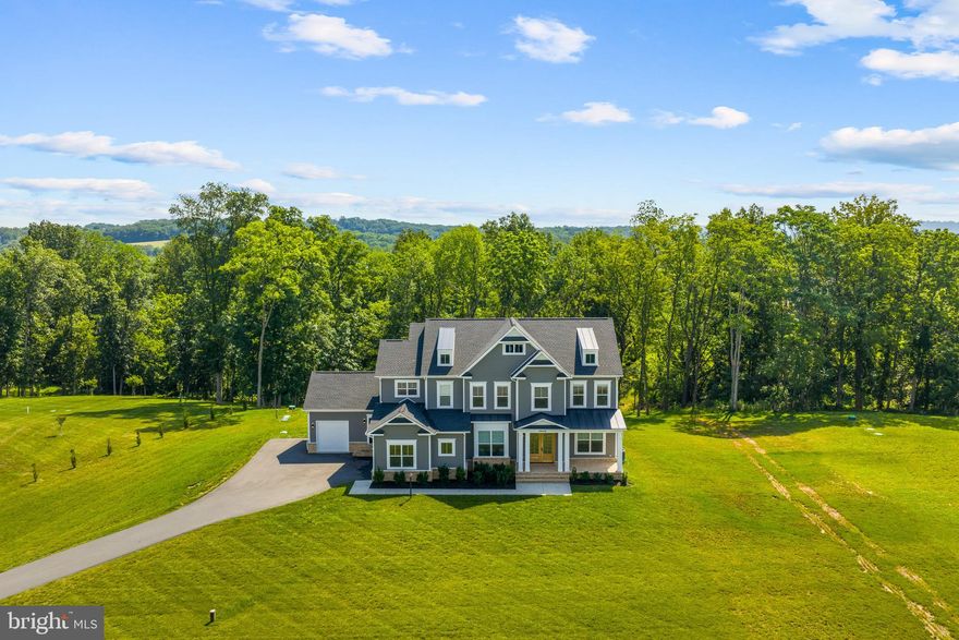 This stunning custom home built by Carrington Homes is set on over two private acres in Purcellville’s desirable Huntridge Preserve community. Built in 2022, this property offers beautiful curb appeal with a stately front elevation, manicured landscaping, and an extended driveway that leads to a spacious 3-car garage with its own dog washing station. Inside, the main level features wide-plank floors, elegant ceilings & mouldings, and an open-concept layout that includes a light-filled living room, a formal dining space, a private office, and a gourmet kitchen with upgraded cabinetry, quartz countertops, a large center island, a walk-in pantry, coffee bar, wine fridge, and wi-fi enabled stainless steel appliances. The upper level boasts four generously sized bedrooms, including a luxurious primary suite with vaulted ceiling and huge windows, two walk-in closets, and a spa-inspired en-suite bath with a freestanding tub, oversized shower with dual shower heads, heated floors, and two vanities. The upper level also includes three additional bedrooms - one an ensuite and the other two connected via a Jack-and-Jill bathroom. The well-appointed laundry room is also on the bedroom level.  The unfinished lower level is a blank canvas waiting for your customization. It has a rough-in for an additional bathroom and walk-up access to the backyard. Enjoy the peaceful setting from the back deck with a gas line for the grill and a screen-in porch surrounded by open green space—ideal for relaxing or entertaining. Located in Huntridge Preserve, a small HOA community with a monthly fee that includes trash and snow removal, and served by well and septic systems for added independence and privacy. Schedule a private tour to make this gorgeous home and lifestyle yours!