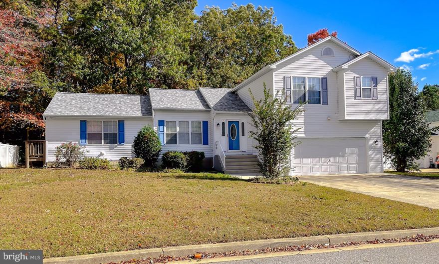 BACK ON MARKET. Buyer financing fell through and this Greenbrier, cul-de-sac home is back with a new list price! This 4-bedroom, 3.5 bath home has so much to love! A BRAND NEW ARCHITECTURAL SHINGLE ROOF,  the 400 sq ft bonus room addition, and tankless water heater are just a few of the great features that make this property a must-see! 30-year shingles provide decades of peace-of-mind! The main floor bedroom/bonus room has its own exit & deadbolt door, attached bath, walk-in closet and outer room. It would make an excellent guest space, in-law suite or "roommate" apartment - or continue to use it as a recording studio as it's all set! Enter this split level home and take note of the fresh paint, cathedral ceiling in the living room, gleaming hardwood floors in the dining room and kitchen, that includes attractive Oak cabinets , Corian solid-surface counters, gas stove, breakfast bar, and pantry closet. The main level is semi-open to the spacious LL family room that centers on a marble & wood-faced fireplace, and walk out doors to the grilling patio. Sliders from the dining area lead out to the back deck - a great set up for entertaining! The lot backs to trees for added privacy. Upstairs has the primary suite with large soaking tub/shower, and walk-in closet. Two other good-size bedrooms, laundry, and shared hall bath complete the upper level. Never run out of hot water with the tankless water heater! Add in a 2-car garage with storage, the included treadmill, a convenient powder room for guests, and a great location minutes from PAX, restaurants and shopping, and you'll have lots to love about this home! Request your showing today!