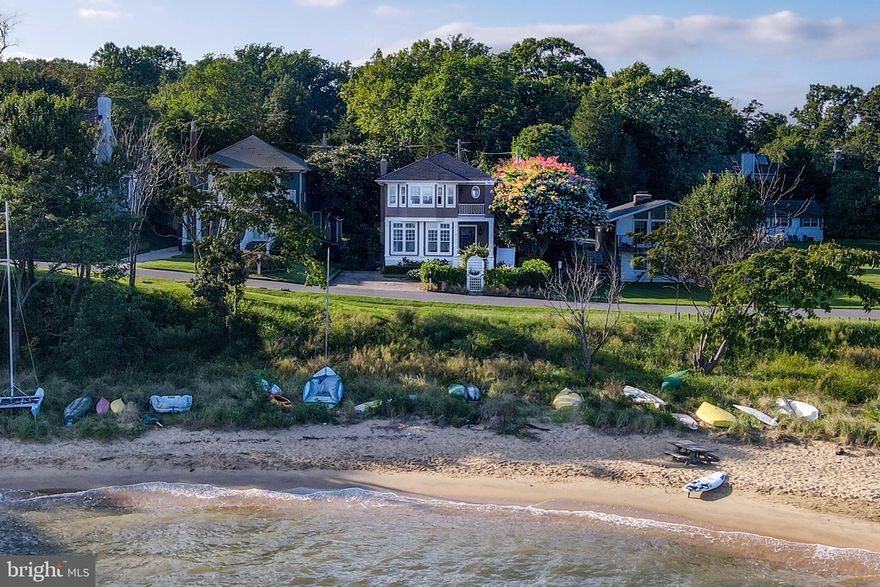 This magnificent home in the heart of the sought-after community of Bay Ridge offers the breathtaking Chesapeake Bay views you have been looking for. This coastal infused home is non-riparian waterfront with direct beach access just steps from your front door. This classic 1930’s home was re-constructed, expanded and renovated to offer a modern floor plan yet still has the original charm throughout.  Features of the main level include a living room with wood burning fireplace, window-wrapped sunroom, gourmet kitchen, separate dining room, cozy sunken family room with custom built-ins & wood burning fireplace, and a powder room.  The top floor offers a fabulous waterfront master bedroom with luxurious bath, large walk in closet, and a balcony overlooking the bay.  This level is completed with three additional bedrooms, a full bathroom, and full laundry room.  The unfinished lower level is perfect for a recreation or play area.   A beautifully landscaped front yard offers bayside seating, a stone paver driveway for three cars and an outdoor shower.  The large rear yard offers a flagstone patio, garden, and endless possibilities to enjoy or entertain.  A storage shed and additional parking for multiple cars can be found at the rear of the property.  The Bay Ridge Community offers a private pool & club house with panoramic Chesapeake Bay views, marina, boat ramp, beach, and playground.  With easy access to Historic Downtown Annapolis & Washington, DC, this Bay Ridge beauty is not to be missed!