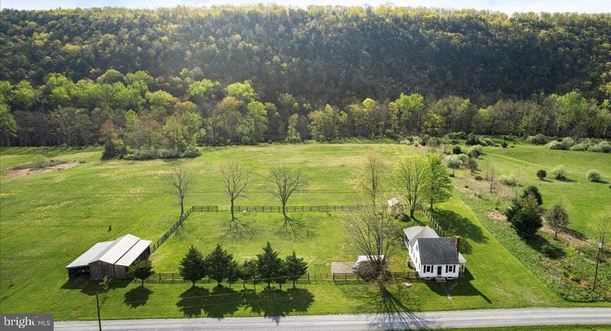 Don't miss out on this extraordinary opportunity to own a stunning property meticulously maintained and ready to be called home! Situated on 20 acres with private river access, this home offers the perfect blend of tranquility and convenience. Featuring a main floor bedroom and two additional bedrooms upstairs, along with an updated and upgraded kitchen boasting modern conveniences, a spacious dining area, and a full hall bath, this home has everything you need for comfortable living. Step outside onto the recently added oversized covered screened porch and take in the picturesque views of the surrounding landscape. With a barn, run-in shed, and electric hook up specifically designed for your RV, this property offers versatility and convenience for all your needs. Whether you're exploring the wooded mountain terrain, meandering along the trails, or enjoying the beautiful fields and river frontage, this gem provides endless opportunities for outdoor adventure right at your doorstep. Located in an established community with large lots, you'll enjoy peace and privacy without feeling isolated. Plus, with breathtaking views in every direction—from pastoral scenes to majestic mountains—you'll never tire of the natural beauty that surrounds you. Don't wait any longer to make this incredible property yours. Schedule a viewing today and experience firsthand the beauty and serenity that awaits you here. This opportunity won't last long, so seize the chance to own your dream home.