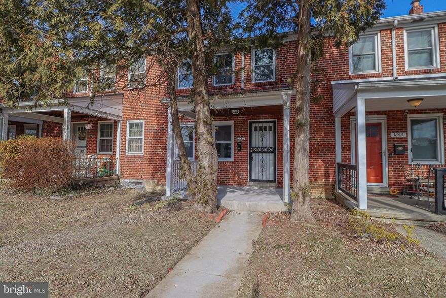 Welcome to your dream home! This beautifully renovated brick-front row house offers the perfect blend of classic charm and modern amenities. With 3 bedrooms and 1.25 baths, this residence is designed for comfortable living.  As you approach, you'll be greeted by a charming covered porch, ideal for morning coffees or evening relaxation. Step inside to discover fresh paint throughout, setting a bright and inviting tone. The main level boasts new luxury vinyl plank flooring, leading you to a completely updated kitchen featuring brand-new cabinets and gleaming stainless steel appliances—a chef's delight!  Upstairs, you'll find three cozy bedrooms, each with new carpeting. One of the spare bedrooms includes custom-built ins, providing extra storage or a stylish display area. The bathroom has been thoughtfully updated to meet modern standards. The expansive lower level offers a massive space with endless possibilities—think home theater, gym, or playroom. Outside, the fenced yard provides a private oasis for gardening, entertaining, or simply enjoying the outdoors.  Don't miss the opportunity to make this move-in-ready gem your own. Schedule a viewing today and envision the lifestyle this home offers