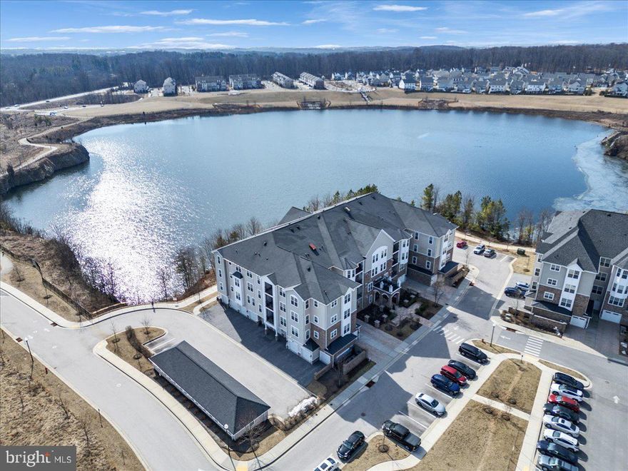 This beautifully designed 2 bedroom, 2 bath condo  is located in the premier 55+ community of Gatherings at Quarry Place. Featuring an open floor plan with gorgeous wood floors, a modern kitchen with stainless steel appliances, versatile den, and a spacious primary suite with a private bath and dual vanities, this home offers both comfort and elegance. Enjoy the convenience of in unit laundry, a private garage, and secure entry. Step onto your balcony and take in breathtaking lake views. Community amenities include a clubhouse with a fitness center, an outdoor pool, and a welcoming community center. Experience the perfect blend of luxury, convenience, and active living!