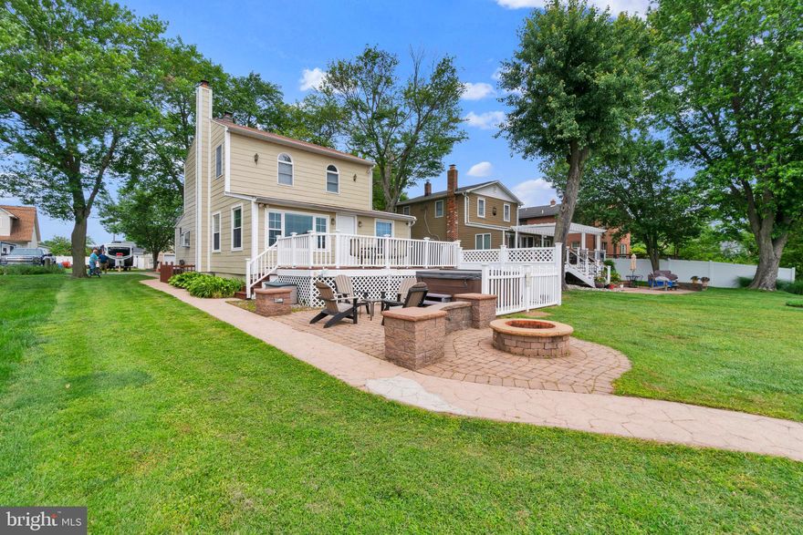 Welcome home to your serene waterfront retreat along Armstrong Creek. The local waterfront restaurants on middle river are just a short boat ride away. This home is perfect for outdoor entertaining or relaxing. Enjoy taking in water views from your patio with a built in firepit & hot tub, deck, or table on your pier. Your sandy beach appears as the tide goes out making launching kayaks a breeze. The pier has 3 slips with additional docking available alongside. The boat lift is rated for 11,500lbs & is great for your safe storage. The pier is also equipped with electric as well as water at the shore. Do you also have a home business? There is a spacious two level garage included with plentiful room to park your favorite classics and a large finished room on the 2nd level with a 1/2 bath. This space is temperature controlled with a ductless split system as well as additional heat from a pellet stove.
Enter your home to the warm living room filled with natural light. There is a Buck brand wood stove for relaxing on those cool nights, powerful enough to fill the home with heat & lowering your energy costs. The island kitchen boasts new coastal lighting gleaming across the stainless steel appliances. Counterspace is plentiful on both sides of the kitchen. The refinished oak cabinetry is of timeless quality & recently painted a desirable neutral. There is bar seating at the island as well as table space at the dining area. A main level bedroom with water views is available for those desiring one level living also boasting a walk-in closet. The hall bath has a tub shower combination. Front load laundry is conveniently on the main floor as well. Upstairs you find a spacious primary suite with a large walk-in closet, seating area, and primary bath with a tile corner shower. Open the windows and feel the breeze from the water driven by two ceiling fans. If a 3rd and/or 4th bedroom is desired, the walk-in closet & seating area could easily be converted back for your current or future desires. Storage is plentiful with a floored attic as well as an actual basement. Have peace of mind knowing this home is located in FEMA Zone X, the 500 year floodplain, lowering your risk as well as expenses.