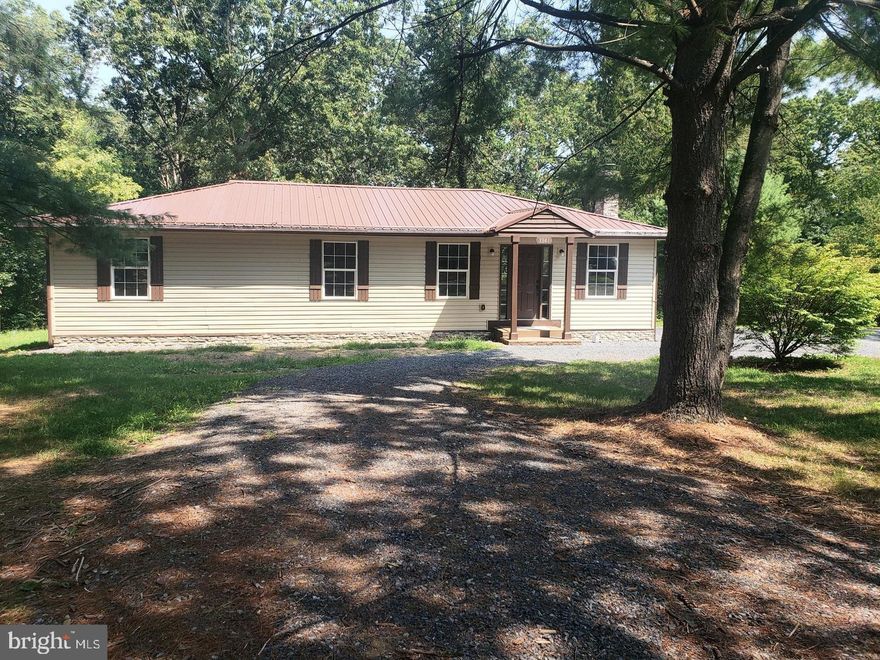 Updated main level living ranch home with luxury vinyl plank flooring throughout.  Spacious living room and  a Large kitchen with Stainless appliances and a spacious kitchen table area. Large primary bedroom and bath with new Quartz counter.  Two additional bedrooms and a second  full hall bath. Laundry room off the kitchen area.   Grill out on the newer deck and enjoy the beautiful tree views on the 1 acre lot. Shed in yard. - located in a no thru street.    The exterior has been completely redone with a new 40 year metal roof, gutters, vinyl siding, and deck to enjoy your peaceful back yard. New Energy Star rated windows and new HVAC system will keep you comfortable year round. Even the Septic and plumbing have been updated. Convenient commuter location on the East side of Winchester. Just 10 minutes from I-81.