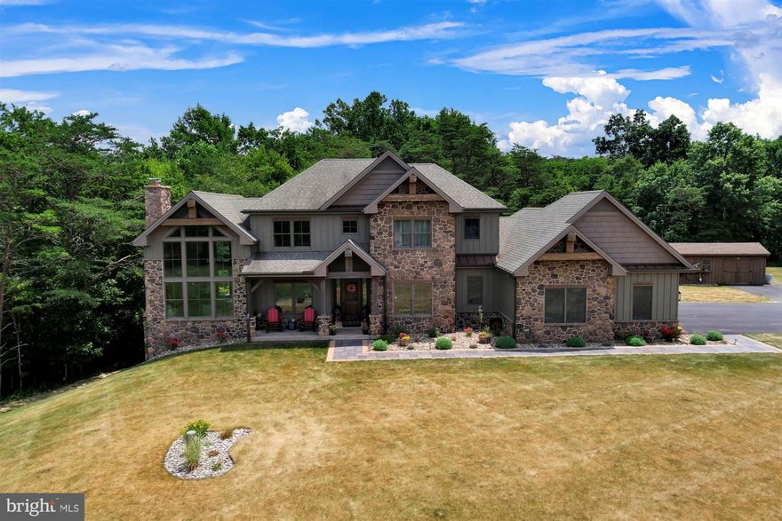 This 5 bedroom, 4.5 bath Lee Roland built stunner sits on 25 beautiful, private acres with the best of all worlds:  amazing views of the Fishing Creek  Valley, woods, a stream.  This rustic feeling, country resort-like retreat has top of the line custom everything all with a convenient location.  Home boasts 2 story Foyer, Living Room with dramatic 20 foot cathedral wood beamed ceiling, amazing Anderson picture windows, tons of natural light and views, white oak hand-hewn hardwood floors, not to mention the gorgeous  stone wood burning fireplace with a locally salvaged barn wood beam mantle -- a phenomenal centerpiece.  Spacious Kitchen has custom locally made cabinets, beautiful mocha suede granite countertops, tile backsplash, wood beamed ceiling, top of the line appliances including Fisher Paykel propane stove, Bosch double ovens & dishwasher, one of a kind black walnut butcher block island and walk-in pantry.    Anderson doors lead to both maintenance- free upper deck and lower covered patio.  First floor office is carpeted, has 9 foot ceiling, and closet.  Dining Room enjoys the open floor plan and views.  The character continues to the main level carpeted Primary Suite which has recessed lighting and bath with porcelain tiled floors, spa tub, tiled rain shower, linen closet and walk-in closet with pocket door.  First Floor laundry and mudroom house all outside necessities (check out the laundry chute).  Don't miss the horizontal paneling in the half bath! Wide Rear Staircase leads to 4 spacious bedrooms with huge closets and 3 full baths with ceramic tile floors (laundry chute is located in closet of front middle bedroom).  Oversized 3 car garage is insulated and has access to above crawl space.  Enjoy additional indoor entertaining space in the marvelous exposed Finished Lower Level: custom bar with handmade concrete countertops, wood burning fireplace, recessed lighting, porcelain tiled floors with dual zoned radiant heat and be sure to observe the napa valley wine barrel rib lights! Unfinished storage area is roughed in for a bathroom, has the radiant heat and houses equipment such as central vac, wires for sound system, electrical boxes, hot water heater for radiant heat, sump pump, geothermal system (for first floor; second floor is heat pump with UV and HEPA filters).  Property is in Clean and Green and receives the Homestead exemption.  1000 gal propane tank is owned and is buried.  GE 2000KV symphony whole house back up generator is located outside the garage and has a smart switch.  Home has hardwired smoke 7 carbon monoxide detectors.  Shed provides storage for outdoor toys and equipment.  Yard hydrant services garden area.  Basketball hoop remains.  25+ acres includes wooded area with stream & firepit area -- a real forest-lovers paradise! Agents, please see Private Remarks