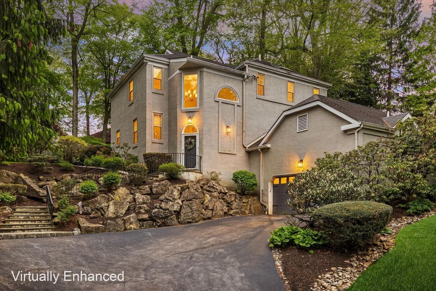 Welcome to 2114 Greenbrier, a stunning 4-bedroom, 2.5-bathroom sanctuary nestled in the highly coveted Villanova community and the acclaimed Lower Merion School District. Tucked away on a peaceful 0.68-acre cul-de-sac lot, this home offers over 3,500 square feet of sophisticated yet inviting living space. It lives like a completely secluded retreat, yet you are just minutes from premium shopping, dining, commuter rails, and top-tier schools, not to mention a short stroll to The Inn at Villanova University, scenic walking trails, and a local dog park. A charming stone-accented stairway welcomes you to a dramatic two-story foyer, where brilliant natural light highlights gleaming hardwood floors and exquisite wood trim. The heart of this open-concept home is the stunningly updated kitchen, showcasing custom cabinetry, rich granite countertops, a sleek glass subway tile backsplash, and a dedicated beverage bar. An oversized center island with chic pendant lighting creates the ultimate hub for daily life and holiday entertaining alike. This culinary space flows effortlessly into a sun-drenched dining area framed by oversized windows and a cozy family room anchored by a warm fireplace—the perfect layout for both intimate dinners and lively gatherings. When you are ready to unwind, sliding glass doors invite you into an expansive enclosed sunroom, perfectly blurring the lines between indoor comfort and the picturesque landscape outside. From here, venture out onto a charming stone walkway that winds through your private garden and lush, sprawling backyard. This incredible outdoor oasis is tailor-made for summer barbecues, relaxing evenings by the firepit, or quiet nights spent stargazing. Back inside, the main floor is seamlessly completed by a private home office, a convenient laundry room, and a beautiful half bath. Upstairs, the luxurious Primary Suite awaits as your personal getaway. It features sweeping backyard views, two custom walk-in closets hidden behind clever pocket doors, and a spa-inspired ensuite bath complete with dual sinks, a large walk-in shower, and a skylight. Three additional generously-sized bedrooms provide plenty of comfort and share a bright, skylit full bathroom in the hall. Downstairs, the finished lower-level delivers exceptional versatile bonus space—ideal for a home theater, gym, playroom, or secluded retreat—with direct access to the two-car garage and ample storage. Offering sophisticated style, a flawless modern floor plan, and unmatched Main Line convenience, this Villanova gem is truly special. Book your showing!