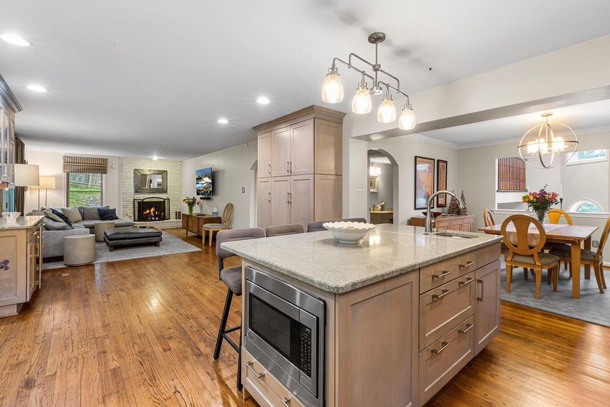 Welcome to 2114 Greenbrier, a stunning 4-bedroom, 2.5-bathroom sanctuary nestled in the highly coveted Villanova community and the acclaimed Lower Merion School District. Tucked away on a peaceful 0.68-acre cul-de-sac lot, this home offers over 3,500 square feet of sophisticated yet inviting living space. It lives like a completely secluded retreat, yet you are just minutes from premium shopping, dining, commuter rails, and top-tier schools, not to mention a short stroll to The Inn at Villanova University, scenic walking trails, and a local dog park. A charming stone-accented stairway welcomes you to a dramatic two-story foyer, where brilliant natural light highlights gleaming hardwood floors and exquisite wood trim. The heart of this open-concept home is the stunningly updated kitchen, showcasing custom cabinetry, rich granite countertops, a sleek glass subway tile backsplash, and a dedicated beverage bar. An oversized center island with chic pendant lighting creates the ultimate hub for daily life and holiday entertaining alike. This culinary space flows effortlessly into a sun-drenched dining area framed by oversized windows and a cozy family room anchored by a warm fireplace—the perfect layout for both intimate dinners and lively gatherings. When you are ready to unwind, sliding glass doors invite you into an expansive enclosed sunroom, perfectly blurring the lines between indoor comfort and the picturesque landscape outside. From here, venture out onto a charming stone walkway that winds through your private garden and lush, sprawling backyard. This incredible outdoor oasis is tailor-made for summer barbecues, relaxing evenings by the firepit, or quiet nights spent stargazing. Back inside, the main floor is seamlessly completed by a private home office, a convenient laundry room, and a beautiful half bath. Upstairs, the luxurious Primary Suite awaits as your personal getaway. It features sweeping backyard views, two custom walk-in closets hidden behind clever pocket doors, and a spa-inspired ensuite bath complete with dual sinks, a large walk-in shower, and a skylight. Three additional generously-sized bedrooms provide plenty of comfort and share a bright, skylit full bathroom in the hall. Downstairs, the finished lower-level delivers exceptional versatile bonus space—ideal for a home theater, gym, playroom, or secluded retreat—with direct access to the two-car garage and ample storage. Offering sophisticated style, a flawless modern floor plan, and unmatched Main Line convenience, this Villanova gem is truly special. Book your showing!
