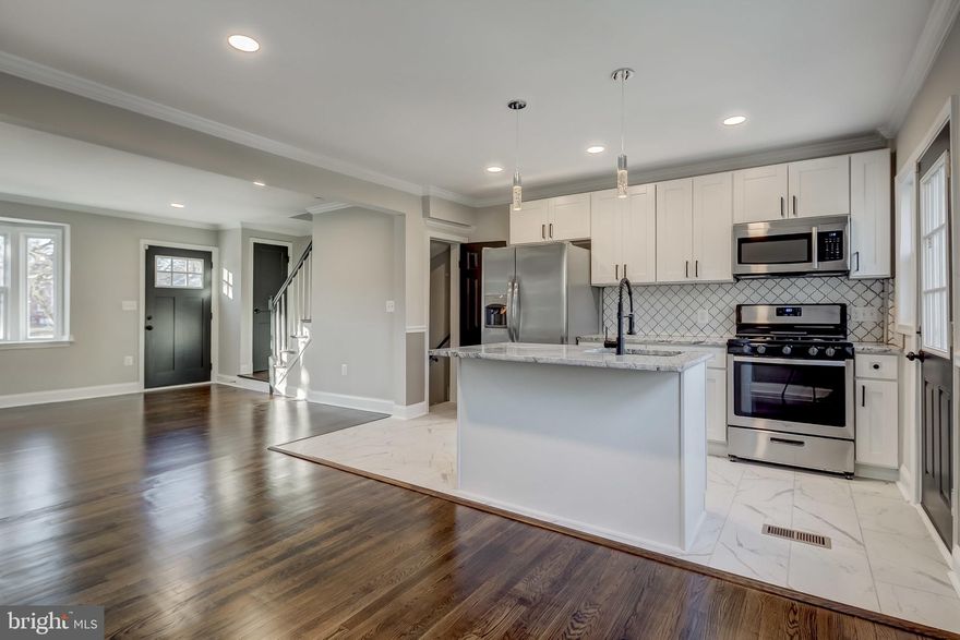 Welcome to this Beautifully Renovated townhouse with stylish finishes located in a well established neighborhood, a bright OPEN floor plan with Modern Amenities and a custom wall paneling. New designer Kitchen w/ Granite Countertops /  Gorgeous Backsplash / Island/ New SS appliances. Gorgeous HARDWOOD floors.  New HVAC, New HWH & Sump Pump, New Windows/ Doors, New Bathrooms with Custom Tile work & so much more. Electric 100% Fully Rewired, Recessed LED lights. FULLY Finished Basement has LVP waterproof flooring and a Full Bathroom and with Rear entrance. No detail has been overlooked. Tons of Natural Light, a back yard mostly fenced great for entertaining and could possibly convert part of the yard into a parking pad ? Convenient to Towson & Morgan state. A great home for all.  PERMITS PULLED & INSPECTIONS PASSED.