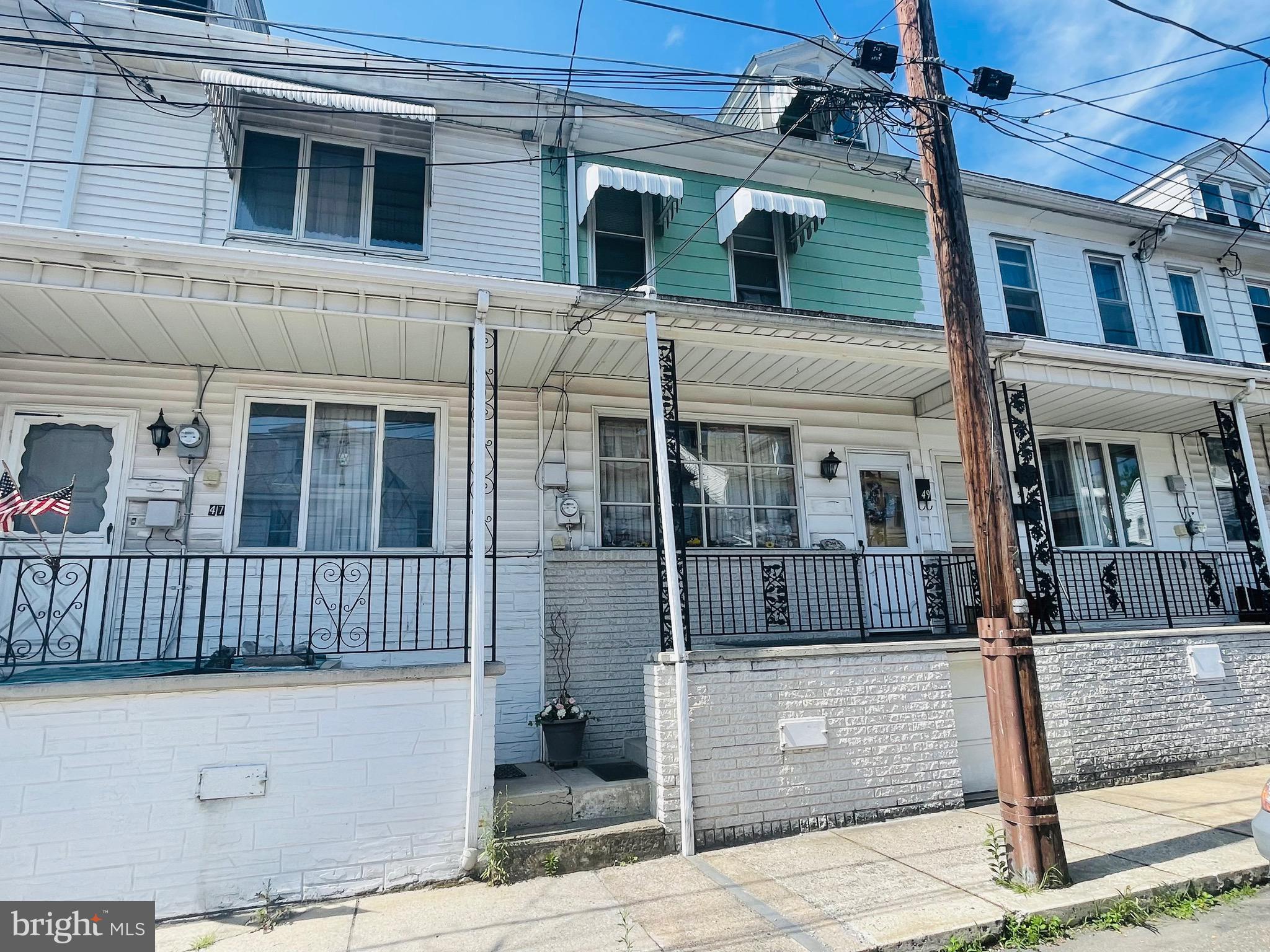 This home has been lovingly cared for by one family for 75+ years!! It is now ready for its new owners. While you may want to update the home, you can easily move right in and make improvements or updates over time. As you enter, you will find a living room, family room, and an eat-in kitchen on the main floor. The upper floor features a primary bedroom, followed by two walk-through bedrooms, and a full bathroom. The middle bedroom also has access to a small covered porch ideal for sitting and reading a book or just enjoying the fresh air outside. The attic could easily be an additional separate bedroom. The washer is currently set up in the kitchen, but could be put back down in the very functional basement. The basement is not finished; however, it is heated, with access to the rear yard, and has been used as extra family space with a table, chairs, crafts, and even a shower. (The sink in the basement is not connected to anything at this time.) This basement does not take on water. The efficient cast iron baseboard not only provides a warmth that wraps its arms around you, it makes heating the home a breeze. Off the kitchen, you will find another small, covered, porch/breezeway, that leads to the fenced rear yard. A shed in the yard offers additional storage options. If you wish, you could even move the shed and use the space for off street parking. One additional perk, is the home is already set up with generator hook ups ready to keep the furnace and refrigerator up and running if there is an electricity outage. The existing appliances and furnishings in the home at the time of showings will remain. Some decor and personal items may be taken by family. Home is being sold AS IS. An appointment is required to tour. Seller will consider FHA financing if buyer includes in writing buyer shall cover all expenses associated with any lender required repairs.