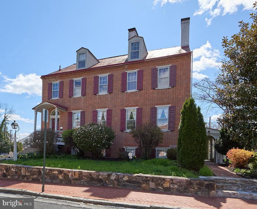 5-Unit in Town Center!!!!     Rarely does a property of such architectural pedigree and versatile potential become available in the heart of the West Chester Borough. Standing as a majestic detached sentinel on a sprawling 0.22-acre lot—a nearly unheard-of expanse for town-center living—this 1830 Federal-style masterpiece is a 6,164-square-foot triumph of history, scale, and opportunity.      From the moment you arrive, the heritage of the building is evident. The stately presence command the streetscape, leading into an interior defined by four stories of grandeur. The home retains its most coveted historic "bones," featuring soaring ceilings, original wide-plank flooring, and five magnificent fireplaces that serve as the heart of its most prominent rooms.     Currently configured as a high-performing five-unit residence, the property is in immaculate condition, offering a seamless blend of modern mechanicals—including a new high-efficiency boiler, on-demand hot water heater, EV charging station in the garage, and wifi keypad locks—and preserved period details. The floor plan is vast and flexible, comprising two massive 3-bedroom units, two 2-bedroom units, and a one-bedroom.  The rooms and units flow and mesh wonderfully, giving you the ability to create an immense single family home, or claim as much space as you need while ensuring income from the rest of the home. While several kitchens and baths have been stylishly modernized for contemporary luxury, the building’s original character remains uncompromised, right down to the authentic root and wine cellar in the lower level.   The exterior is an urban sanctuary. The gorgeous courtyard and expansive yard offer a private, lush retreat for grand-scale outdoor entertaining, complemented by the convenience of a detached two-car garage.  Situated in the vibrant Town Center, you are steps away from the curated dining and boutique shopping that define West Chester’s booming culture.   Currently three units are rented out as Airbnbs (first and second floor on the floorplans), one is a monthly rental (fourth floor), and the owner occupies the last (third floor).  The three-bedroom unit on the top floor has separate heat and electric. Only one electric meter for the lower three airbnb  units.  Owner pays heat and hot water for all units except the top floor in addition to water and sewer for the entire building.