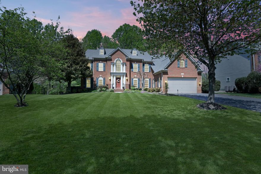 Welcome to a rare opportunity to own the largest model in the Villages of Urbana! This beautiful NV Monticello with fantastic curb appeal is perfectly situated on the most serene court with a wooded green space just across from it. Offering nearly 8,200 square feet of luxurious living space, this exceptional home features a smart, elegant layout with 5 spacious bedrooms each with its own ensuite bath and walk-in closet. As you step inside, you will be welcomed by the grand two-story foyer with dual staircases and intricate custom molding. The stunning sun-drenched two-story family room showcases floor-to-ceiling windows, an impressive coffered ceiling, a cozy fireplace, and a custom built-in entertainment center. The gourmet kitchen is perfect for entertaining and everyday living– with its abundant white cabinetry, large center island, granite counters, custom tile backsplash, stainless appliances, double oven, and a walk-in pantry!  Enjoy the convenience of a back staircase just off the kitchen.
The stunning morning room is filled with natural light from windows on every wall, offering beautiful views of mature trees and bringing the outdoors in. The dining room with classic chair rail provides the perfect space for entertaining guests, while the living room adds even more room for everyday living and family gatherings. The large office, featuring custom built-in bookshelves and cabinetry, is the perfect place to work from home.
On the upper level, the elegant Primary Suite offers a tranquil retreat with a separate sitting area, tray ceiling, and two fantastic walk-in closets —including one oversized walk-in, complete with a window and custom built-ins! The spa-inspired bath features a custom-tile steam shower with dual shower heads and a built-in bench, dual granite vanities, a soaking tub, and a separate water closet.
The fully finished walk-up lower level is an entertainer’s dream and features a living area with a cozy gas fireplace, a large recreation area–perfect for playing pool or watching TV–and a wet bar with granite counters, a dishwasher, and a refrigerator!  Enjoy showing movies in the media room with a projector and theater seating! The versatile bonus room with an ensuite full bath– can be used as a bedroom, a workout room, or craft room. 
With loads of closets and storage spaces, this home makes it easy to be organized! The convenient mudroom, located just off the 35-foot deep multi-car garage, features a built-in welcome center with a bench & cubbies/hooks, and a separate coat closet — providing the perfect place to store and organize your belongings when entering the home. In the spacious laundry room, you will find loads of cabinetry, a utility sink, and a convenient counter for organizing laundry!
This home’s outdoor living spaces are just as impressive — the extra-long driveway provides plenty of parking for guests, while the large, flat front yard shaded by mature trees offers the perfect space for play and relaxation. The private backyard oasis backing to the woods features a custom stone patio with a built-in outdoor kitchen, making it ideal for outdoor entertaining and gatherings.
Situated in a great commuter location, this home also provides access to all of the highly-sought after amenities of the Villages of Urbana, including three resort-style pools, clubhouses, tennis & basketball courts, fitness centers, walking trails, and much more. Walk or Bike to the Market District of Urbana--with its shops, eateries, grocery store and library. With highly-ranked schools, parks like the Urbana District Park, and the new South County YMCA, this home offers the best that Urbana has to offer! Don’t miss this exceptional home in an unbeatable location!