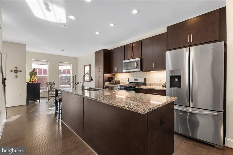 GORGEOUS 3BR/3.5 BA 4-level contemporary, luxury townhome in sought-after Crescent Place subdivision - walking distance to downtown Leesburg, shopping, restaurants, Farmer's Market, W&OD Trail, parks, and great proximity to all the wineries and breweries and charming history Loudoun has to offer! Beautiful, open floor plan on the main level includes inviting living room with gas fireplace plus built-ins and access to balcony; the gourmet kitchen includes an extra-long island kitchen, upgraded granite countertops, stainless steel appliances, custom glass backsplash and gas cooking; convenient dining area and main level half-bath rounds out this level. The upper levels offer 3 bedrooms and 3 full baths, plus a top floor den/entertainment area with granite countertop, refrigerator, wine rack and cabinets that open to the roof top deck with stunning view and Sunsetter retractable awning. 2-car garage and storage space. Custom window treatments throughout. Early 2024 updates: whole house interior professionally painted in modern neutral colors, new high quality carpet in all three bedrooms, contemporary matching ceiling fans in all bedrooms, and updated contemporary recessed lighting throughout. Easy commuter access to Route, 7, Route 15, and the Dulles Toll Road!