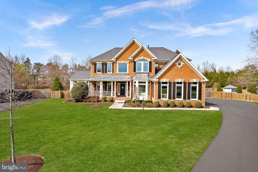Set on a private, wooded homesite in the heart of Ashburn, this exceptional cul-de-sac residence offers a rare blend of seclusion, sophistication, and fully integrated smart living. Tucked away yet minutes from everyday conveniences, the property delivers a lifestyle that feels worlds apart—where privacy, innovation, and comfort exist in perfect balance.

Almost completely reimagined in 2020 with a no-expense-spared approach, the home has been transformed into a truly connected smart residence. Nearly every light, system, and function—from climate and security to whole-home audio—is app-controlled and seamlessly integrated. Thoughtful infrastructure upgrades including a whole-house surge protector, leak detection with automatic water shutoff, and high-efficiency systems (roof, HVAC, and dual Navien tankless water heaters all updated in 2020) provide peace of mind alongside luxury. Sonos speakers in every room, custom built-ins, flat wall vents, and Pella windows with between-the-glass blinds reinforce the level of detail carried throughout.

The interior balances modern design with warm, highly functional living. The kitchen is a true showpiece, outfitted with a full suite of designer appliances including a Big Chill industrial refrigerator, 48” gas range, Miele built-in coffee system, steam oven, and more—blending performance with statement design. Supporting spaces like the butler’s pantry elevate everyday living with a full refrigerator/freezer set, ice maker, pull-out storage, and hidden outlets. The dining space is equally impressive, with custom cabinetry, color-changing LED shelving, and a dual-temperature wine fridge.

The primary suite offers a true retreat experience, complete with a retractable ceiling-mounted TV, custom-designed closet with island and rotating storage, and even an LG steam closet for garment care. The spa-inspired bath features a dual steam shower, heated floors, heated towel rack, cast iron soaking tub, and smart mirror cabinetry—creating a space designed for both relaxation and performance. (And yes—there’s a hidden feature you’ll want to see in person.)

The fully finished lower level continues the home’s elevated design, featuring coffered ceilings, a sound-insulated brick feature wall, and a modern open staircase with sleek railings. This level offers exceptional flexibility for entertaining, recreation, or extended living, with a dedicated gym space (that can easily convert to a fifth bedroom), a full bath, and multiple areas for gathering or relaxation.

Outdoor living rivals that of a private resort. A renovated pool with sun shelf, a separate hot tub, expansive decking, and multiple entertaining zones are complemented by a fully equipped outdoor kitchen with grill, griddle, smoker, and refrigeration. The StruXure motorized louvered roof system—on both the main deck and private office deck—automatically responds to weather, with integrated lighting, screens, heaters, and fans creating year-round usability. Landscape lighting, uplighting, irrigation, permanent Jellyfish lighting, and whole-property Sonos audio complete the experience, all set against a mature tree-lined backdrop for exceptional privacy.

Additional highlights include an oversized garage with dual EV chargers, epoxy flooring, built-in cabinetry, and boot heaters; extensive storage solutions including fully-enclosed  under-deck storage; and countless thoughtful upgrades designed for both convenience and longevity . Many furnishings were custom-made or purchased for this home & may convey.

This is more than a home—it’s a thoughtfully engineered lifestyle. With advanced technology, exceptional craftsmanship, and indoor-outdoor living executed at the highest level, this is a truly rare offering for those who expect both beauty and performance from where they live. Home provides easy access to Ashburn Metro Station, Dulles Airport, Loudoun County Parkway, Route 28 and Dulles Greenway and Toll Road,