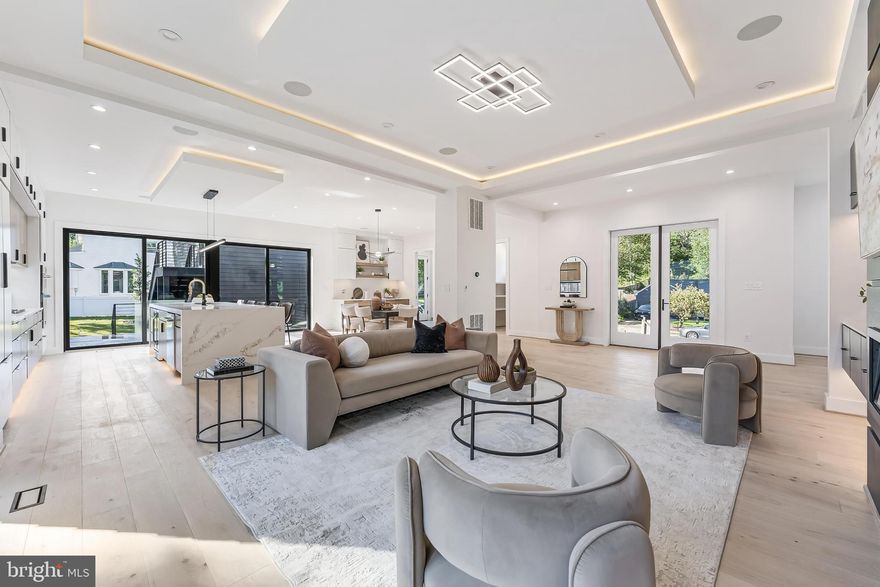 ASK ABOUT BUILDER 3-2-1 RATE BUY DOWN FOR LOWER MORTGAGE PAYMENTS.  Welcome to this one-of-a-kind dwelling which blends mid-century exterior form with modern interior design.  It was designed by Axis Architects and backed by a Builder's Warranty.  This striking 5,600 SqFt custom build is situated on  1/3-acre premium, fenced corner lot, with a 400 SqFt apartment loft atop the detached garage (22'x20').  It spans 3 levels with 5 bright bedrooms and 5 luxurious baths (main house).  Garage parking for 2-cars, plus 4-car driveway, and 6-car curbside!  This home features an unrivaled open-concept plan perfect for modern living and entertaining. The stunning living room boasts 10-ft inverted tray ceiling with LEDs, Bluetooth ceiling speakers, fireplace accent wall, and deck access.  The gourmet kitchen features 10-ft waterfall quartz island, JennAir stainless appliances, two-tone cabinetry, walk-in pantry, and sgd to a second Trex deck.  On the main level, there is also an office, bedroom, and full bath.  Next to the dining area is a side door that leads to the mud room with a built-in bench and a pet washing station. A dramatic floating staircase with a corner wall of windows leads up to the vaulted family room with 15-ft ceiling height, skylights, and balcony access door.  The primary suite features floor-to-ceiling windows, luxurious soaking tub and shower, walk-in closet, dry bar, and private access to the balcony. Two other ensuite bedrooms and a separate laundry room complete the upper level. The open basement boasts a large recreation area, gym, wet-bar, ensuite bedroom, and walk-up stairs to the rear yard. The Bel Air neighborhood is tucked away yet minutes from major highways, I-495, I-66, Rt 50, East Falls Church Metro, and key destinations, such as, the Mosaic District, Tyson's Galleria, and Inova Fairfax Hospital.