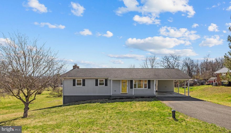 Located minutes from downtown Berryville and Route 7, this Clarke County ranch offers more than 3 bedrooms and 1.5 baths;  it offers a quieter way of living. Set on 0.75 acres along a peaceful cul-de-sac of established homes, the property enjoys a tucked-away feel, where nearby farms and open countryside define the landscape instead of congestion and noise.
Renovated in 2018, this warm and welcoming home is filled with natural light. Large windows highlight beautiful hardwood floors, showcasing character and quality that are increasingly hard to find.
The main living room flows into the dining area and kitchen, creating an easy layout for everyday living and entertaining, with an overlook of the large deck and expansive backyard.
The primary bedroom features a nicely updated half-bath ensuite. A second generously sized bedroom stands out with stylish wainscoting, while the third bedroom is conveniently located across from the updated full hall bath.
The expansive lower level offers excellent additional living space centered around a cozy wood stove insert. New carpet runs throughout, and a flexible bonus room provides ideal space for a home office, hobby room, or spare bedroom. A dedicated storage room, laundry area, and exterior access add everyday convenience.
Outside, the property offers versatility and freedom with no HOA restrictions. The large backyard is well- suited for play, gardening, hobbies, or gatherings with family and friends. A generous carport leads directly to the side entrance for easy daily access and sits conveniently across from an additional storage room.
Superbly located just minutes from downtown Berryville with quick access to commuter Route 7, this property offers the ideal balance of peaceful country living and everyday convenience.