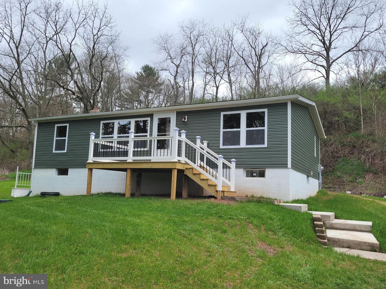Affordable & Adorable - Country setting for this beautifully renovated rancher on one acre lot, 3 bedrooms, 2 full baths, open floor plan, all new walls, floors, ceilings, new kitchen and new bathrooms, new lighting, new tilt windows, new decks, full unfinished basement with outside exit...imagine the possibilities. Detached double garage, perfect for the hobbyist. View of trees, stream and pastures. Great getaway property or year 'round living. Located 1.5 miles from I-70. Garage lies within 100 year flood plain. This is truly a gem. Call today to schedule your showing.