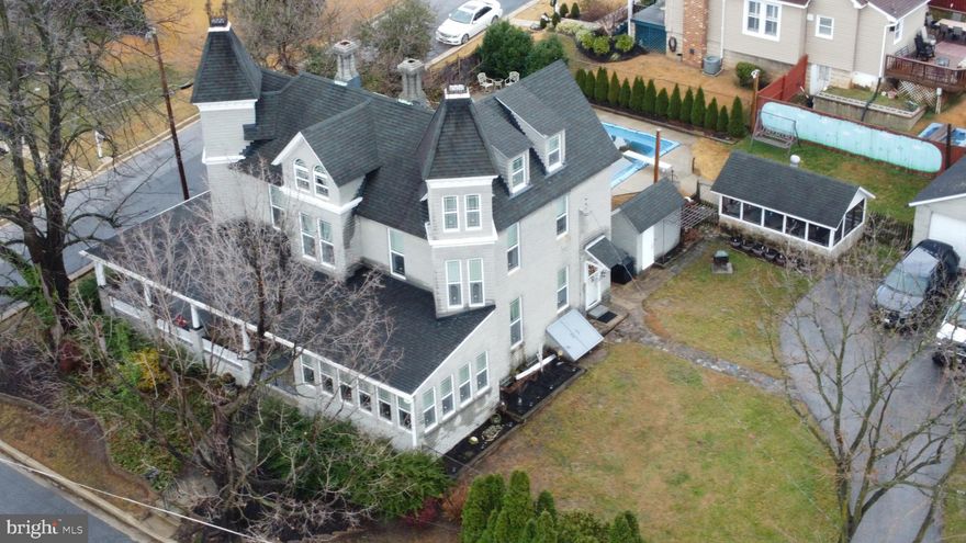 Limited showing availability and no overlapping appointments. Contact your agent to reserve a time. Additional details, utility info, property history information is attached to the disclosures.  Your agent can download it for you.

Stunning Victorian-style home on a beautifully situated corner lot featuring a wrap-around porch, 16×32 in-ground pool, fish pond, and multiple detached structures including a 2-car garage, large parking pad, screened pool house, pool dressing/storage house, kids’ playhouse, and natural gas grill — a true private backyard oasis. Inside, the main level offers a spacious 7x15 foyer, 10 ft ceilings, an elegant study that flows into a private office, and a private staircase (separate from the main stair) leading to the primary suite. The bright family room showcases 13 windows and connects to the dining room with a fireplace and detailed custom millwork. The kitchen includes a gas range, oversized pantry, and walk-through laundry with an exterior door. A powder room and three main-level exits complete this floor.

The second level includes 3 bedrooms and 2 full baths, with a primary suite featuring a dressing area and generous closet space. The upper level provides 2 additional bedrooms (one with an apartment-style kitchenette) plus an 8x8 storage room in between the two upper level rooms. The exterior offers manicured grounds and multiple entertaining zones — providing exceptional character, privacy, space, and versatility.