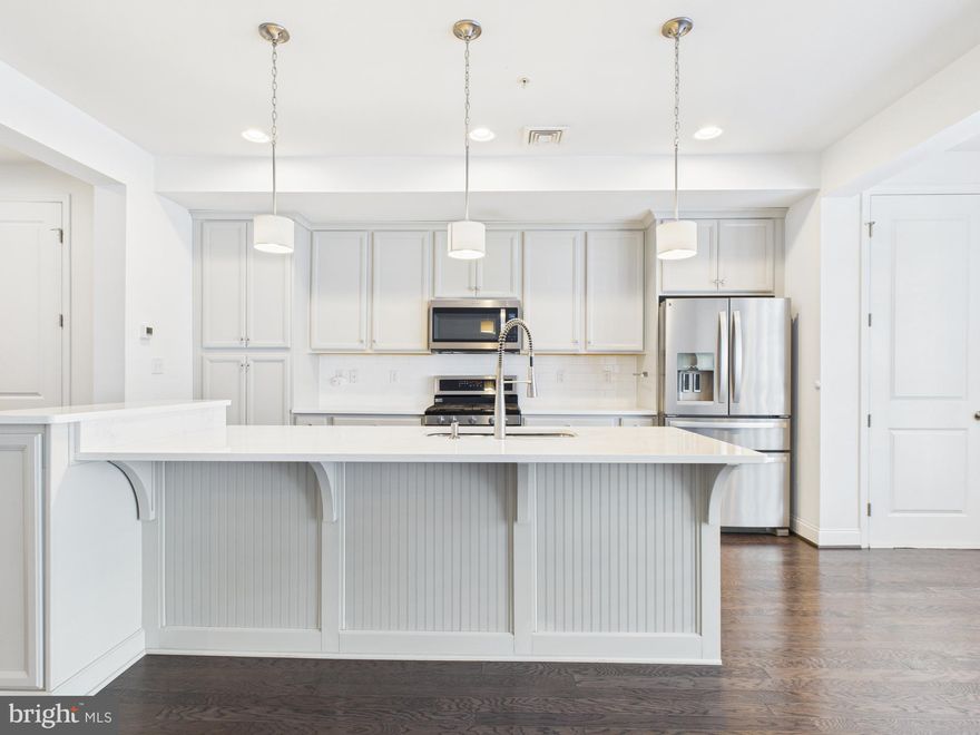 Welcome to 418 Mayer Place in the desirable Belmont community! This stunning 2 BR, 2.5 BA townhome-style condo offers modern design, high ceilings, and an open floor plan perfect for entertaining. Enjoy a gourmet kitchen with granite counters, stainless appliances, tile backsplash, and a large island with seating. Spacious primary suite includes a walk-in closet and private bath. Second bedroom has its own full bath—ideal for guests or office. Features include hardwood floors,  gas heat, and garage parking. HOA covers exterior maintenance and landscaping for low-maintenance living. Walk to Target, Whole Foods, Starbucks, and dining at The Shoppes at Belmont. Minutes to Rt 30, 283 & 222! Move-in ready and beautifully maintained.