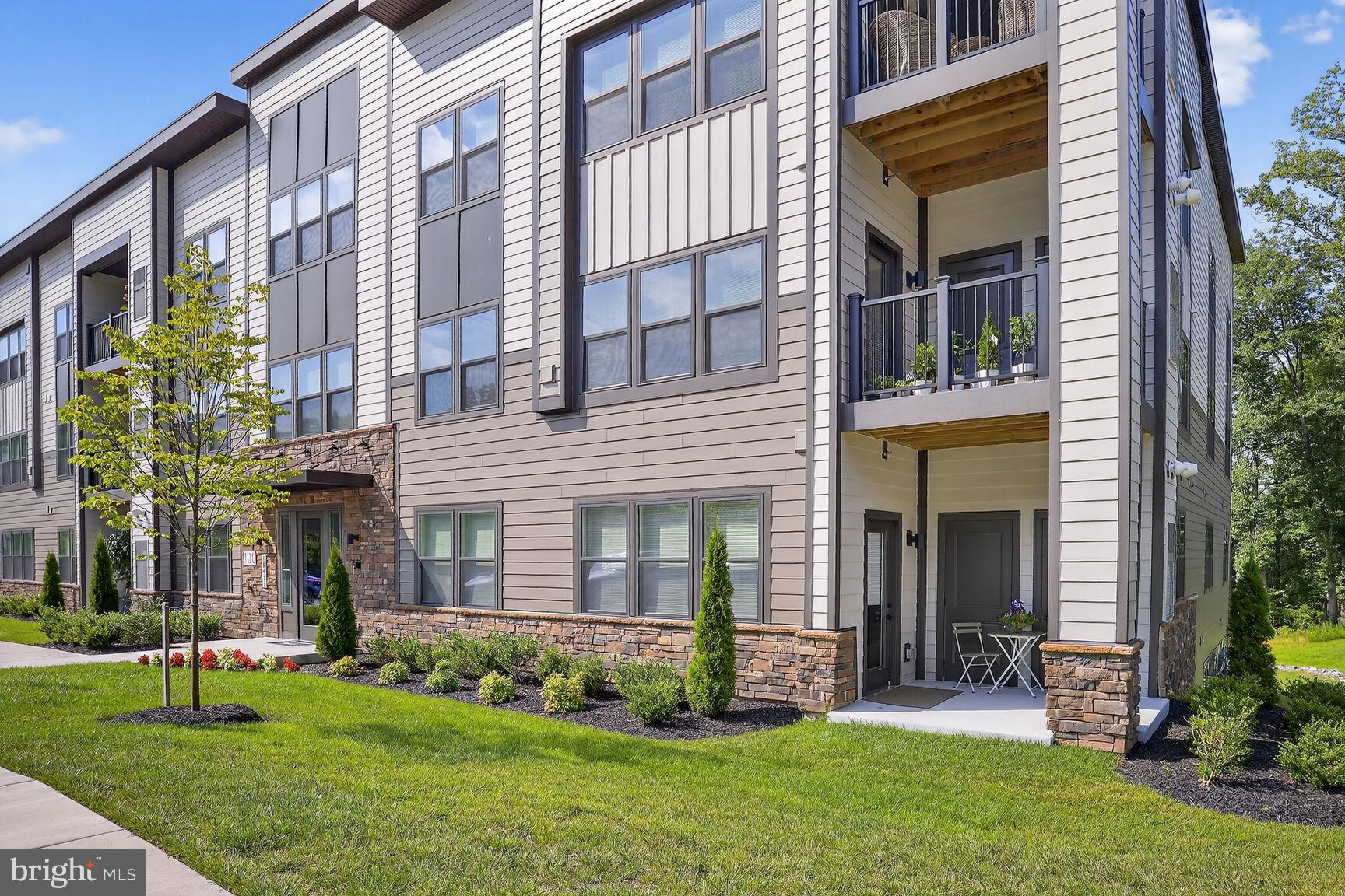 Welcome to luxury and convenience in this beautifully appointed 2-bedroom, 2-bath main floor condo in the heart of sought-after Turf Valley. Only 2 years old, this spacious home features an open floor plan with hardwood floors, oversized tile, and designer finishes throughout. The gourmet kitchen is a chef’s dream, complete with quartz countertops, a gas stove, and modern cabinetry. The primary suite offers a large bedroom and a private en suite bath for added comfort. Enjoy easy living with in-unit laundry, a walk-out patio perfect for morning coffee or evening relaxation, and no stairs to navigate. The building’s water bill is included in the condo fee, adding even more value. Live just steps from Turf Valley Resort’s unmatched amenities—golf, gym, tennis, spa, hotel, indoor and outdoor pools, and a variety of restaurants and shopping, including Harris Teeter. Conveniently located near major routes, this is resort-style living at its finest. Don't miss this opportunity!