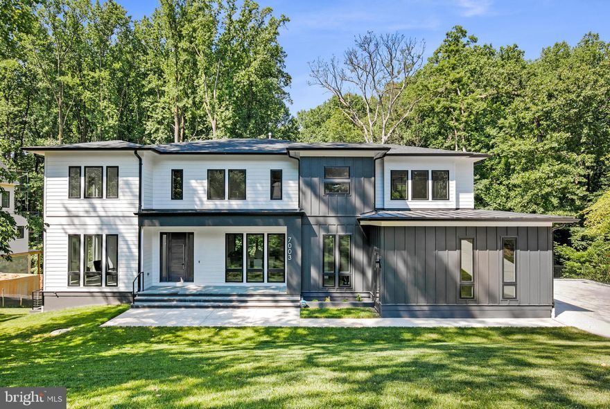 Introducing beautiful new construction in Langley Forest, one of McLean's most esteemed neighborhoods. Nestled on a cul-de-sac, this home exudes class and sophistication. It features a gourmet kitchen, complete with an additional, second prep kitchen, a large walk-in pantry, and a butler's pantry, making it perfect for culinary enthusiasts. The kitchen seamlessly opens to the family room, creating a warm and inviting space. The separate dining room is ideal for elegant dining experiences, and a dedicated office provides a private workspace. In addition, multiple walk-outs provide seamless access to the backyard oasis.  The upper level boasts four bedrooms, including a luxurious owner's suite with a sumptuous bath. The distinctive multi-tiered basement features two additional bedrooms, an exercise room, and an open family room with a fully appointed wet bar, creating an unparalleled living space. The three-car garage leads to a convenient mudroom with a dog shower and an additional washer and dryer. This one-of-a-kind home is designed for making timeless memories and offers a prime location, making it a commuter's dream with easy access to Tysons Corner, Washington DC, and all major commuter routes.