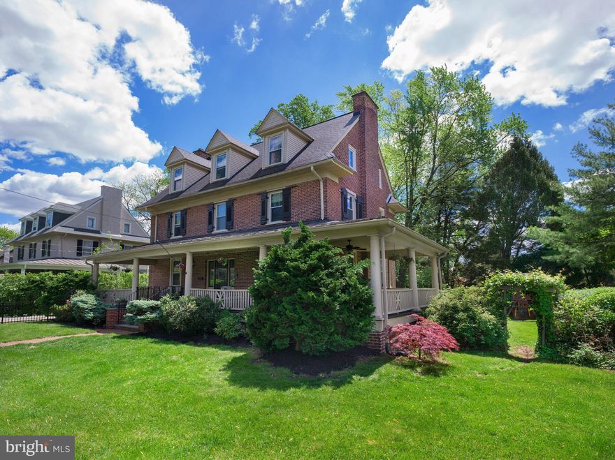 Historic Charm Meets Modern Comfort in the Heart of Ardmore. Just steps from Suburban Square and the Ardmore train, this grand 1910 brick colonial offers a perfect blend of historic charm and modern comfort. The property backs up to Packer Park, a hidden gem known only to locals, providing a semi-private, natural retreat for dog walks, gardening, and outdoor gatherings, with direct access through a private gate.  At the heart of this home is the sweeping wrap-around porch, often referred to by neighbors as the “house with the amazing porch.” Perfect for summer evenings or rainy-day conversations, this spacious, covered retreat sets the tone for the welcoming atmosphere that awaits inside. Step through the stately grand foyer, where 9-ft ceilings, classic moldings, and exquisite millwork make a striking first impression. Oversized, deep-silled windows and 4 beautiful fireplaces create a warm, inviting atmosphere throughout, while original architectural details evoke the home’s historic roots. The dining room features 3 chandeliers and a marble fireplace, ideal for both intimate dinners and large gatherings. The living room is wrapped in upscale, neutral grasscloth wallpaper with a fireplace, while the light-filled family room offers custom built-in shelves, a fireplace, and a large bay window overlooking the lush backyard. The re-envisioned kitchen combines classic elegance with modern convenience, featuring Carrara marble convex tile, glass display cabinets, stainless steel appliances, granite countertops, and updated hardware and fixtures. A well-thought-out mudroom leads to a back porch, perfect for grilling and herb gardening, with a lattice-work storage unit for added convenience. Upstairs, the primary suite is a true retreat, complete with a wood-trimmed fireplace, his and her closets, and a luxurious marble bathroom with heated floors, double sinks, dual rain/wand shower heads, and a separate water closet. The hall bath on this level features a large vanity, deep, oversized claw foot soaking tub, and a linen closet. Two additional bedrooms on this level include one with board-and-batten molding and the other with a private en suite bath, for a total of 3 full baths on the 2nd floor. The 3rd floor provides 4 additional spacious rooms and a full bath, offering flexible space for guests, a private au pair living space, exercise room, or home office. The finished basement adds even more versatile space, including a large playroom, wine cellar, and ample room for storage – ideal for everything from recreation to organized living. This home has been thoughtfully upgraded to enhance both efficiency and comfort, including a new roof, tankless hot water heater, two-zone HVAC, high-efficiency gas boiler, new windows, new fencing, landscaping, and a refinished driveway. The exterior has been meticulously maintained, with fresh paint on the porches and the entire interior (2025), as well as the front porch roof (2020). An outdoor storage shed adds practical storage, while an electric outlet on the front porch provides added convenience for outdoor entertaining. Originally built for one of 3 sisters of the MacFarland estate, this home is filled with preserved historical details, from the original wine cellar shelves to the hardware on the porch once used to hitch horses. Thoughtfully renovated over the years the home’s original wood beams and brick pillars speak to a level of craftsmanship rarely seen today. Enjoy a short walk to the Suburban Square train, providing convenient access to Philadelphia and even New York City on the Paoli/Thorndale line. Walk to Maman for coffee, shop at Trader Joe’s, or catch live music and family events at Suburban Square – this home offers the perfect blend of suburban tranquility and urban convenience. Located in the award-winning Lower Merion Schools , with a choice of high schools, this home truly offers the best of both worlds – a historic retreat with all the modern conveniences.