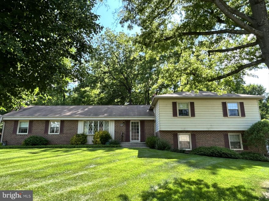 Large four-level split home in Enterprise Estates in Bowie! Lovely and generous front yard and private wooded area directly behind property/back yard. Brick/vinyl home features TWO large living rooms, a wood-burning fireplace, a dining room and your kitchen on walk-in level. Two-car garage opens at back of home and the driveway can fit six more vehicles; enter mudroom area where a large pantry/wine racks and kitchen greet you! Two sinks in kitchen, white appliances and plenty of room for an eat-in area. Hardwood floors in dining room and under all carpeted areas, just waiting for your special touches! This Delaware model home features a larger primary bedroom with three closets and a larger tub/shower in the primary bathroom. Glass sunroom off the lower-level rec room that boasts a second wood-burning fireplace. Large workbench on rec room level; fourth bedroom and half bath off hallway; lower basement level is unfinished and houses your utilities, a full-house Kohler built-in generator, Maytag washer and dryer and a stand-alone chest freezer! Please enter home from side garage door.