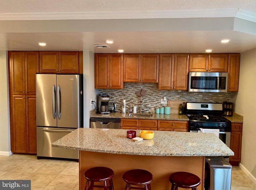 Available May 3. Sunny, open, remodeled condo with parking. Wall to wall windows with peaceful tree top view. Update open concept kitchen with oversized granite island, new cabinets, stainless steel appliances, tile floor, back splash. Huge bedroom closet and french doors to maximize space and light. Wonderful layout for sunlight and entertaining. Shared laundry on ground floor. Permit parking in lot. Pool, exercise room, dog run, community room. Onsite building manager. Utilities and parking free! Simple and easy commuting location and steps to parks and retail.