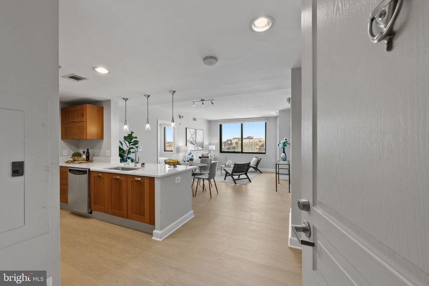 A rare opportunity at Midtown Alexandria Station, residence #1401 is a fully upgraded, high floor 2BR / 2BA with balcony and two side-by-side garage parking spaces!  Located at the end end of a quiet hallway while still being convenient to the elevators, this corner unit offers sweeping views of the Alexandria skyline from the oversized windows.  Upon entering you are immediately struck by the gorgeous, new wide-plank flooring throughout the kitchen, living area, and two bedrooms - no more kitchen tile!  The kitchen features sparkling new quartz counters, stainless steel appliances with gas cooking, and contemporary soft-closing cabinetry.   The intelligently designed floor plan has an open kitchen / dining / living area with bedrooms on either side of the living area.  The owner's suite offers two closets with custom shelving to maximize space and an en-suite full bathroom.  The guest bedroom offers ample space for a bedroom and/or home office with a second full bath perfect for guests.  Enjoy fresh air, your morning coffee or an evening sip as you take in the expansive views from your 14th floor balcony.

Midtown Alexandria Station is a 5-star condominium community of 368 residences constructed in 2007. Quality concrete and steel construction across 16 stories, 4 high-speed elevators, and all the amenities you could wish for: two party room / lounges, 7th floor rooftop pool, spa and tiki bar with huge sundeck, fully equipped fitness center with cardio, strength training and yoga/massage room, onsite guest suite that is fully furnished and available for just $150 per night, and 24/7 concierge plus property management onsite.  Low condo fee includes water/sewer/trash and all amenities - owners just pay an individually metered electric and a low gas bill. Conveniently located directly across the street from the Huntington Metro (yellow line) with easy access to: Old Town; Hoffman / Carlyle area with Wegman's grocery, AMC Theater, Atlas Brew Works / Andy's Pizza; Pentagon; Reagan National Airport; downtown DC; Andrews AFB; Ft. Belvoir & Quantico...just two stop lights to 495!