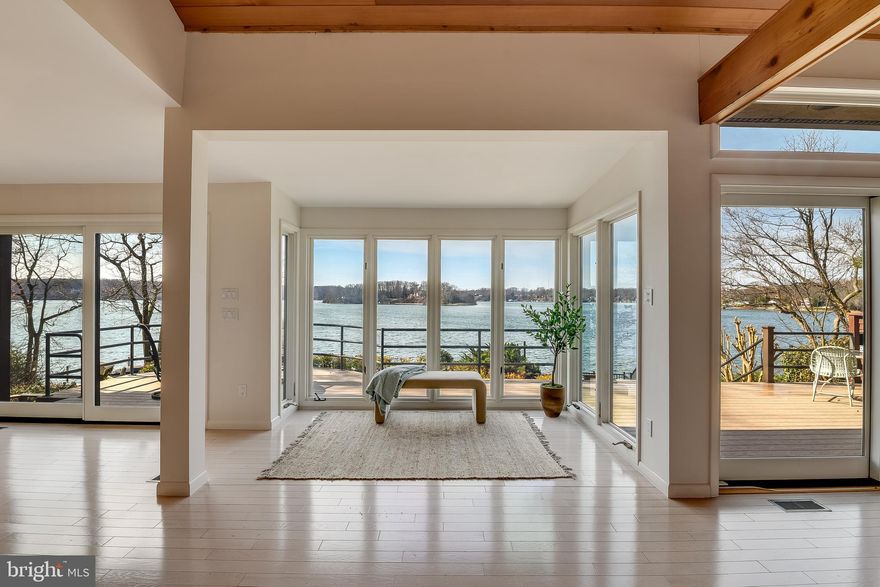 Experience the beauty of waterfront living at 245 Long Point Road on sought-after Little Round Bay. Perfectly positioned across from St. Helena Island, this stunning home offers breathtaking water views and effortless indoor-outdoor living.

Inside, the open floor plan is designed to capture the views, featuring a dramatic family room with cathedral ceilings, a cozy gas fireplace, and an exceptional kitchen equipped with premium appliances and generous space for gathering and entertaining. A loft overlooking the main living area provides the perfect setting for a home office or study.

The spacious primary suite is a private retreat with two walk-in closets and a dedicated vanity room, while two additional bedrooms and 3½ baths offer comfort for family and guests. The lower level provides ideal space for a theater or recreation room, adding flexibility to the home’s thoughtful layout.

Step outside to a Trex composite waterside patio with stairs leading to the private pier. Boating enthusiasts will love the boat lift, two jet ski lifts, and water and electric. Above the boat lift is a party deck - an incredibly rare waterfront feature that can no longer be permitted today - making this an exceptional and highly coveted amenity for entertaining and enjoying views of Little Round Bay!  A multi-purpose shed with electricity offers great potential as a storage space, workshop, or waterfront bar for entertaining.

With incredible views, exceptional waterfront amenities, and a peaceful setting on Little Round Bay, this home offers the very best of the Chesapeake Bay lifestyle.