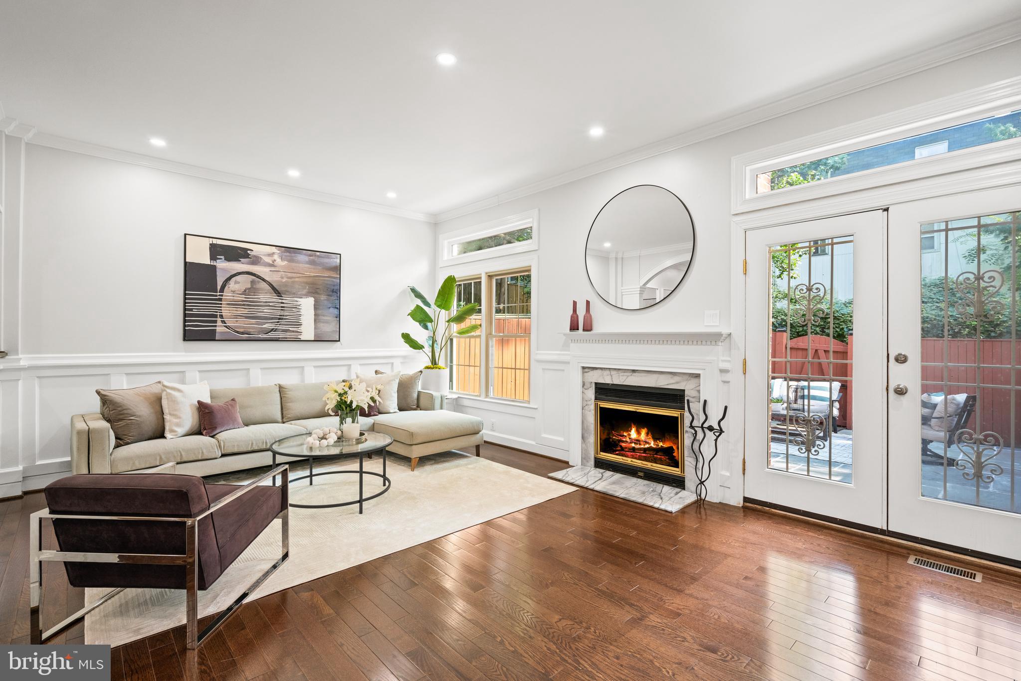 Welcome to this rarely available, largely renovated all-brick 3-level garage townhome in the Churchill School District. Ideally situated at the end of a beautiful, secluded tree-lined cul-de-sac, this spacious home offers stylish living space, blending classic charm with modern upgrades.
The main level features a marble foyer, a striking entirely renovated eat-in kitchen with floor-to-ceiling windows, quartz countertops, custom cabinetry, new appliances, and modern tile flooring. Beautiful hardwood floors lead to the formal dining room with crown molding and custom millwork and arched columns that open to a living room with a cozy wood-burning fireplace with marble surround, and light-filled floor-to-ceiling windows. Glass French doors lead to a private fenced-in slate patio, perfect for outdoor entertaining. A newly renovated half bath completes this level.
Upstairs, hardwoods continue throughout three spacious bedrooms abundant with natural light, brightened by multiple skylights, including one in the hallway and another in the luxurious primary suite spa bathroom. The (2022) primary bath features a Porcelanosa double vanity with KRION Solid Surface sinks and countertop, freestanding Wyndham Collection soaking tub with center drain, walk-in rainfall shower with custom glass pebbled shower flooring and niche, custom lighting, and Grohe chrome fixtures throughout. The fully renovated upstairs hall bath (2022) includes updated tilework, vanity, niche, lighting, and sliding glass shower doors. One of the secondary bedrooms includes custom California Closet bookshelves, ideal for a home office or reading retreat. Ample storage is available via pull-down attic access.
The finished lower level offers a generous recreation room with custom built-in shelving, new ceramic flooring, a second wood-burning fireplace, a stylish half bath renovated in 2025 with Porcelanosa vanity, mirror and sink, new flooring, and a spacious laundry/utility room with new flooring, utility sink, and 2023 energy-efficient washer and dryer. This level also provides direct access to the one-car garage and driveway.
Recent upgrades include a new cedar shake roof (2021), new and refinished hardwood floors (2023), recessed lighting throughout (2025), HVAC (2016, serviced 2025), water heater (2017), energy-efficient windows and appliances (2022–2023), copper piping for main and internal waterlines, and ceramic tile flooring in the basement (2023). The fenced rear patio was re-leveled and refinished in 2025.
Don’t miss this rare opportunity to own a beautifully updated, move-in-ready townhome in one of Potomac’s most desirable locations. A peaceful retreat surrounded by nature—yet just minutes to world-class shopping, dining, and transit—7822 Oracle Place is ready to welcome you home.