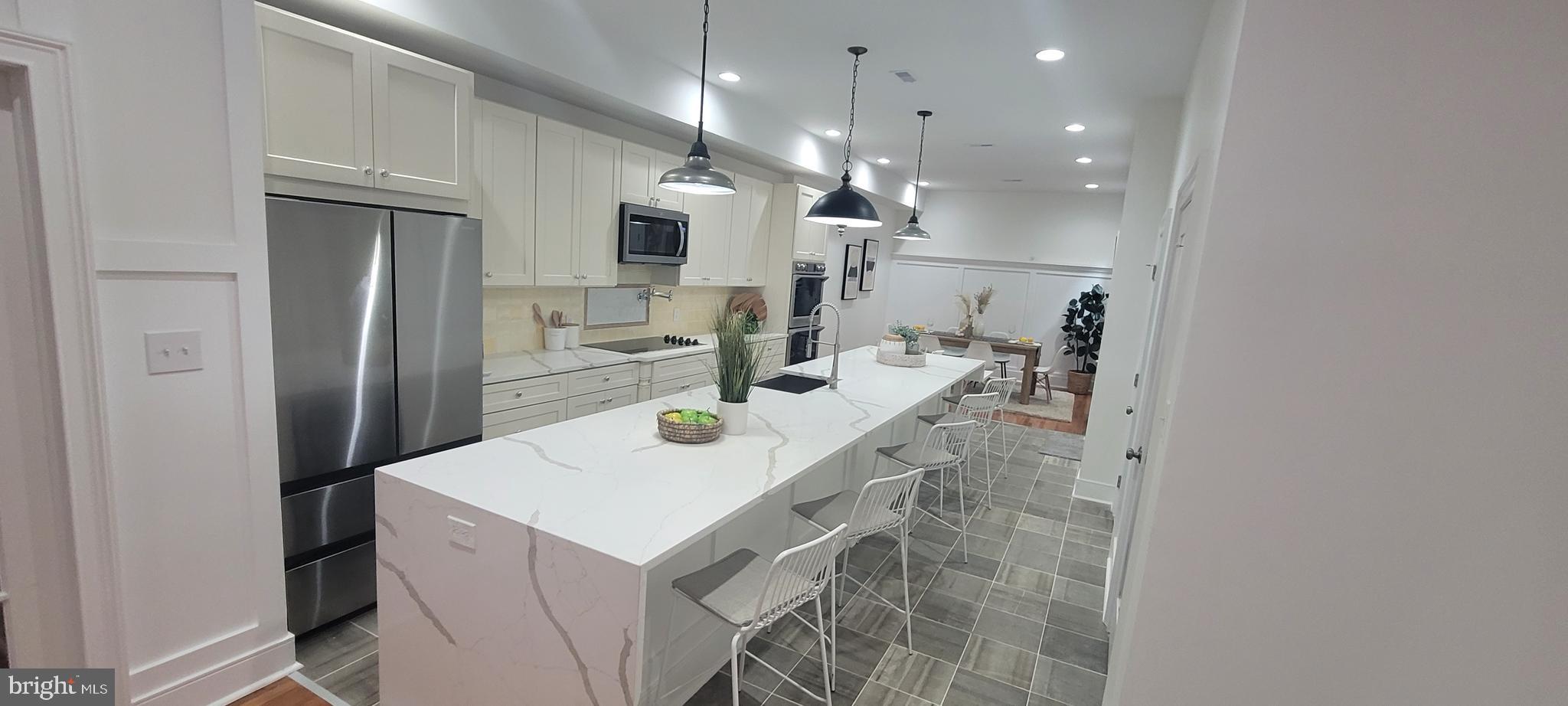 Huge price reduction!!!
Unmatched 5br/4.5 bath masterfully renovated brownstone style Baltimore townhome. Larger than most any home around. There are multiple bedroom suites with private bathrooms and large closets, but the master bedroom suite is unmatched in all of my 25+ years of selling Baltimore. The bedroom itself is huge and walks out onto the 1st deck overlooking the maintenance free yard. But more importantly it leads to the gigantic rooftop deck where some of the best entertaining in Baltimore is bound to take place. It overlooks the City as far as the eye can see. The master bedroom closet is larger than some bedrooms and leads to the master bath with high-end toilet, A BIDET, shower with dual showerheads and separate controls. princess soaking tub, and 2 separate high-end vanities. on opposite sides of the bathroom, so each person has their very own space! Now down to the other unmatched feature -- the kitchen. I dare you to find a larger island in Baltimore! It is an entertainer's dream. It is the perfect fixture for this high-end gourmet kitchen with built-in wine cooler, A POT FILLER at the stove. Separate double wall ovens, stainless dishwasher and fridge, upgraded quartz counters! Just very high-end fixtures and finishes. Other main level features include huge pantry, powder room, spacious living room, elegant formal dining room. The works!!! The basement is finished with private full bath for den or bedroom usage. Heating and air consist of 2 fully separate zoned systems, so you don't have to heat or cool the entire home simultaneously. You can save a lot of money with this type of system. The unique parking feature is similar to what many DC homes offer with a roll-up door where you can just push a button and park in your driveway just like a garage and close the door behind you with the push of a button.
I could go on and on, but you really have to just see the house. The neighboring properties to the right are being torn down by the City, so this block is slated to be one of the best in Baltimore, period!
Nothing like this property has ever been done in Baltimore.
NOTHING.
AT.
ALL.