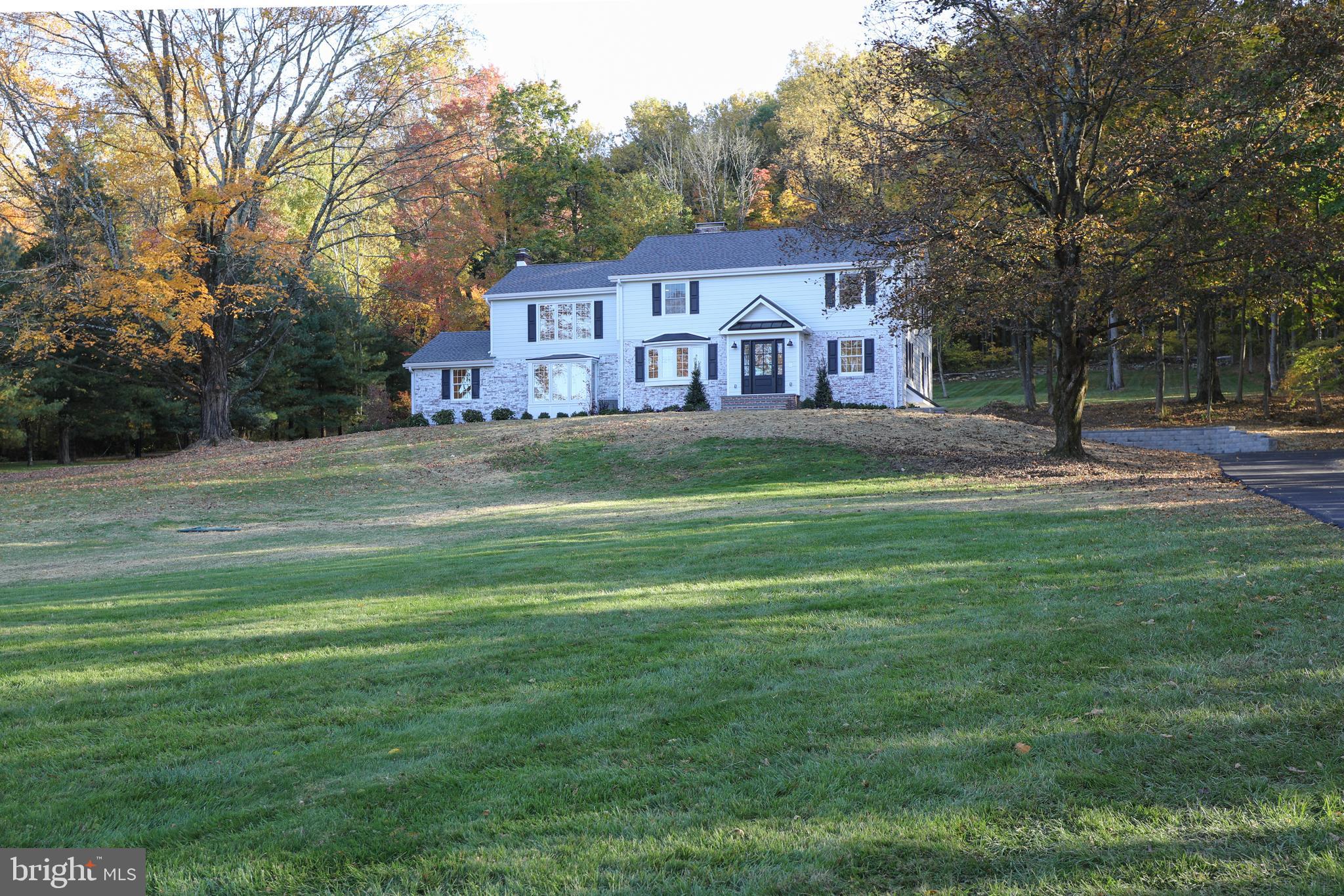 Completely renovated light drenched 5 bedroom, 3.5 bath farmhouse style home situated on almost 6 spectacular acres on one of the most desirable roads in Solebury Township. Welcome to 2317 Aquetong Rd in beautiful New Hope, PA. As you meander down the new driveway you are greeted by the tranquil setting and beauty of this “new construction” home. Fabulous details include a brand new 5 bedroom septic system, new Hardi Plank siding, sheathing and rainshield, new insulation, new windows, new lifetime GAF ultra HDZ shingle roof and standing metal roof, new gutters, new gourmet culinary kitchen with Thermador kitchen appliances including a 36” gas range with Wi-Fi, steam wall oven, microwave, French door refrigerator, Brizo kitchen faucet and pot filler and oversized center island, new exterior door and slider, new garage door and openers with Wi-Fi, new plumbing throughout including water heater and pump tank, new HVAC system with propane heat and Wi-Fi thermostat, new 200 amp electrical panels, new recessed lights, new outdoor lighting, new interior fixtures, new Electrolux washer and dryer, new cabinetry and vanities, new Quartz kitchen counter top, butlers’ pantry top and laundry room top, new Quartzite vanity counter top and heated towel rack in new primary bathroom, ¾” hardwood floors throughout with Bona HD traffic mate finish, electronic locks on exterior doors and so much more. The oasis in the backyard is not to be missed. As you relax with a cup of coffee you can enjoy the open backyard or take a walk up the ½ mile chipped wood walking path into the woods of your 5.88 acres of property. One of the bedrooms and baths is on the first floor if you have parents or guests you would like to host. There is a wonderful office if you are working at home. Dining room with butler’s pantry, den with fireplace, living room with fireplace and powder room complete the first floor. The 2nd level features a primary suite with bathroom, 3 additional nicely sized bedrooms, bathroom with double vanities, and laundry room. Award winning New-Hope Solebury School District. Close to restaurants, schools, and shopping. This is just the move-in ready house you have been waiting for. Be in your beautiful new home for the holidays!