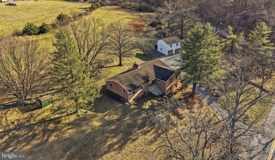 Brick Rancher with Guest Apartment & Scenic Country Views
Nestled in a peaceful country setting and surrounded by large tracts of  farmland, this spacious brick rancher offers privacy, open views, and timeless appeal.  This timeless beauty  provides comfortable living with a seamless connection to the surrounding landscape.  All unrestricted land.   Hobbyist, gentleman farmer, home business...    If you want to grow your own vegetables, have a goat and a few chickens  no problem.    Create your own family compound.     

A detached garage with a one-bedroom apartment offers exceptional flexibility—perfect for guests, multigenerational living, or a private retreat. Enjoy tranquil mornings, wide-open skies, and the sense of space that only a true rural setting can provide.

An ideal property for those seeking privacy, versatility, and classic construction in a serene countryside location.

CaCapon River access is close by.    The little town of Capon Bridge has plenty to offer.   The River House is a coffee and delightful lite fare with live music venue.  It also offers outdoor concerts in the summer,  community jams, arts and crafts for the kids, open mic night, poetry, etc...  The Farmer's Daughter which is a farm to table butcher who also offers amazing lunches, several locally run restaurants such as El Puente, Bent River Trading Post for local handcrafted wares, farmer's market in the summer.   Library, churches, post office, etc... The middle and elementary schools are located in Capon Bridge.