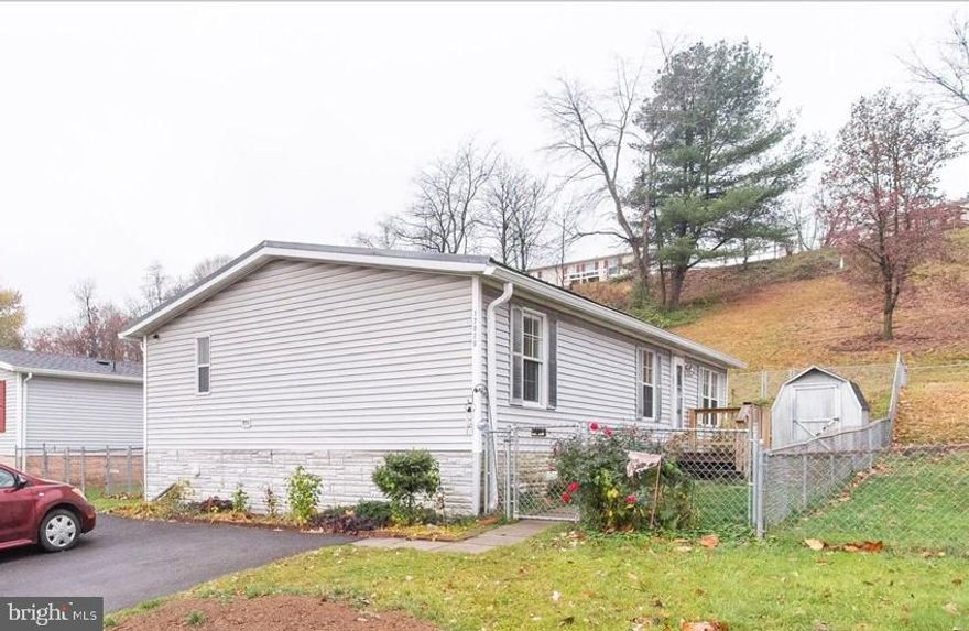 This home is perfect for someone looking to add some sweat equity or someone interested in renovating and flipping for profit.  Priced below after improved market value, this home offers some recent upgrades to get you started.  The home has newer metal roofing added in 2022.  Kitchen appliances are stainless steel with the dishwasher approx 2 years old.  The owners added an electric fireplace off the dining area that includes a tile surround and built-in blower.  Trane Central Air and Natural Gas forced air heating.   This home does need work and will not qualify for FHA, VA or USDA loan programs. 
The home is a manufactured home that has been permanently anchored to a concrete pier foundation.  The home has no lot rent and sits on a 0.10-acre owned lot.   Once renovations are complete these homes can be financed using FHA, VA or other government insured loan programs.