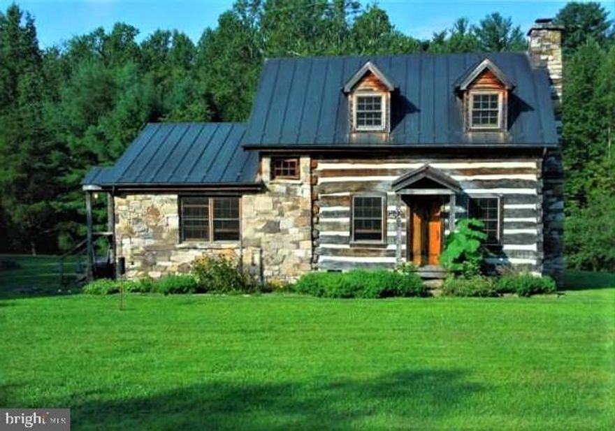 LOOKING for a charming FARMETTE custom Log cabin on 5.5 acres? Welcome HOME to your perfectly sized dream property! This Gorgeous Custom one-and-a-half story Log Home was constructed from a relocated 19th century hewn log home, & re-built  by renowned Stone Mason/Builder Charles McRaven (2003). Located in Northwest Albemarle County, the home has sweeping views of the Blue Ridge and other surrounding mountains. The Log Home offers  2300+ "total" Sq ft , hardwood floors throughout, gorgeous beamed 9+ft ceilings, copper roof, copper gutters/downspouts, stained glass windows, tons of natural light,  beautiful stone wood burning fireplace w/french doors leading a sleeping porch (views of mountains/wildlife all around), random width oak plank flooring throughout, top of the line stainless steel appliances, granite countertops, custom re-claimed wood cabinets, sub-zero refrigerator/freezer,  gas cooking, vintage porcelain kitchen farm sink in the kitchen, Guardian whole house generator, downstairs half bath w/ huge vintage porcelain double sink (used to be a darkroom), one large loft bedroom with walk-in cedar closet & full bathroom w/storage. The exterior of the Log Cabin offers amazing stonework, partial basement w/walkout & storage. The Farm offers Pond(back of home), trees border the farm, pasture is appx 4 acres w/3 board fencing, run in, frost free hydrant, 2 car Carport (log & concrete), & old storage barn/workshop (said to be one of the oldest barns in the county). Best uses Hunt Box, private home, getaway cabin, AirBnB, or investment property. Location is amazing  UVA 20 min, Massanutten 30 min (skiing, hiking), Charlottesville 35 min, Richmond & Warrenton 1.20 min. Countless local artisans, Antiques shops, wine vineyards, Skyline Drive, & Fine Dining. 

If you seek serenity & the joy of the outdoors your best life awaits...