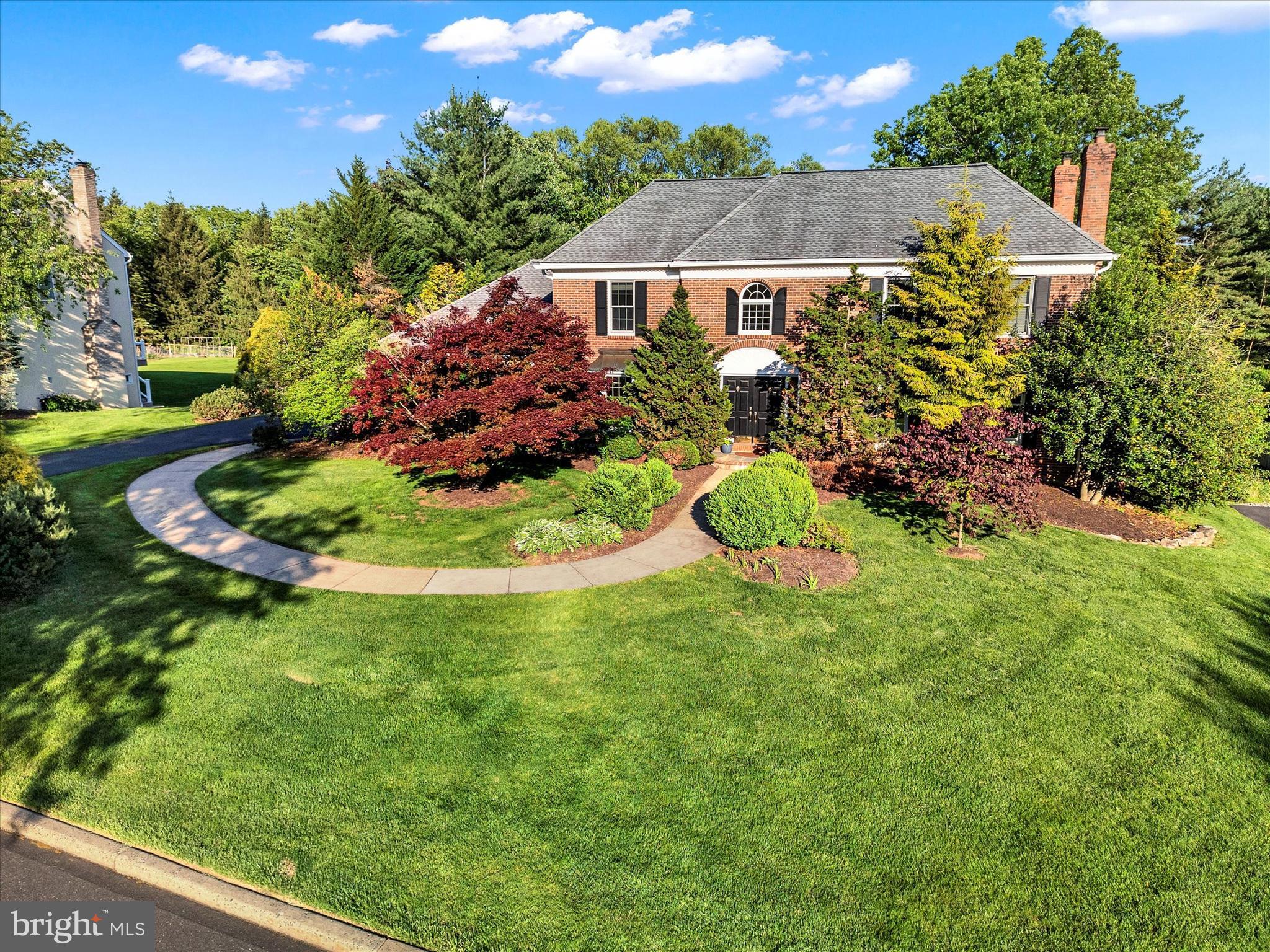 Welcome to this stately brick-front "Oxford Federal" model, a former sample home showcasing timeless elegance & thoughtful upgrades throughout. This center-hall colonial features a dramatic 2-story foyer & gleaming hardwood floors. The formal living room offers classic crown & dental molding, picture frame accents, a wood burning fireplace, recessed lighting, & built-in speakers. The elegant dining room is equally appointed with crown & chair molding, a built-in window seat & recessed lighting.
At the heart of the home lies an expansive open-concept space connecting the kitchen, family room & sunroom - all with hardwood floors. Enjoy cozy evenings in the Family Room by the wood burning brick fireplace flanked by transom windows, or gather around the built-in entertainment center to watch your favorite movie. French doors offer a seamless transition between living & family rooms. The sunroom features a built-in window seat with storage, radiant heat flooring & dual desks ideal for work or crafting. The gourmet warm cherry kitchen offers 2 huge islands, granite countertops & tile backsplash with Mercer Tile inserts, Miele dishwasher & pantry.
Step outside to your very own private oasis—featuring a Trex deck overlooking lush perennial gardens that attract butterflies & hummingbirds, plus a sparkling saltwater pool (heated) perfect for summer fun. A gorgeous gazebo adds year round enjoyment, complete with speakers, a fan & electric. A large laundry room with custom built-ins & utility tub, powder room, mudroom with cubbies & 2nd utility tub, plus a 3-car side entry garage complete the main level.
Upstairs, the luxurious primary suite includes a sitting room, expansive walk-in closet, & a peaceful spa-like bath with skylight, tile & glass shower, & stand alone soaking tub. Three additional spacious bedrooms share a well-appointed hall bath & generous closet space.
The fully finished walk-out lower level includes a bedroom or office, exercise room, sliders to the backyard & pool, it has roughed-in plumbing for an additional bath. Recent updates include Level 2 EV charger (2023), whole house water softener, booster pump for water pressure (2021), new water heater, roof & Andersen windows (2016), all downspouts drain away from the house underground, 5 zone irrigation sprinkler system that uses well pump (new) as source, Bose speakers included 4 inside & 2 outside, 2 sump pumps, all mechanicals serviced regularly, 9 ft. ceilings throughout 1st floor, Solar panels are owned & transfer with the house, adding $1,400 per year of extra value in electricity. Truly a must-see property offering space, style, comfort inside & out! One mile from Peace Valley Park, downtown Doylestown & all of its restaurants, museums & library, not to mention the Award Winning Central Bucks School District!