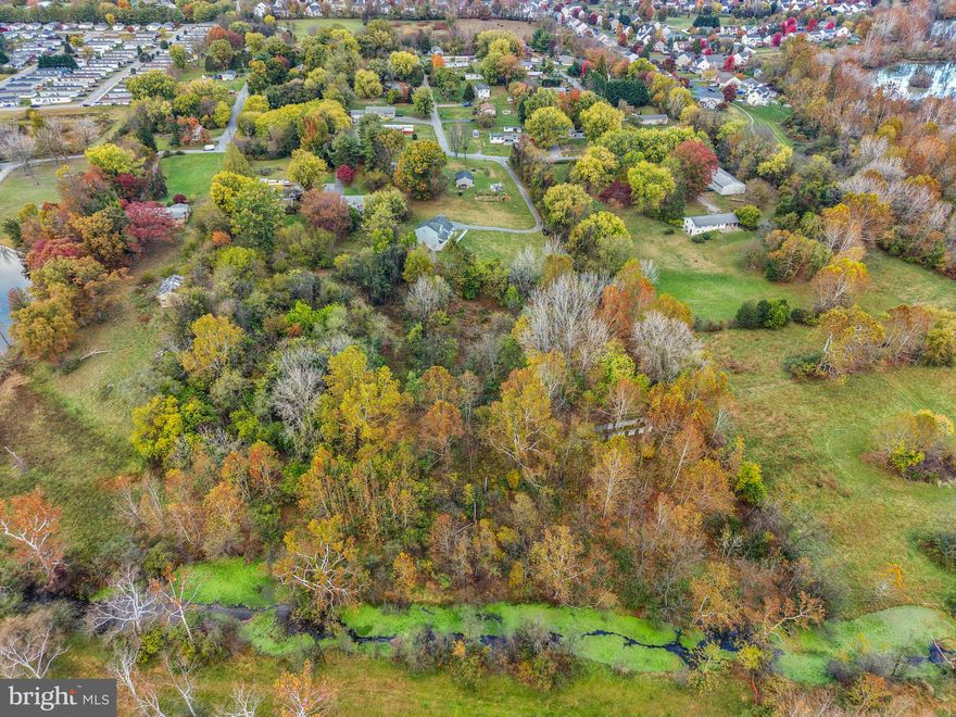 Your Urban Oasis Awaits!

Discover an exceptional opportunity to build your dream home right in the heart of the city. This spacious lot offers the perfect balance of urban convenience and natural serenity, with approximately 250 feet of frontage along the picturesque Flowing Springs Run.

Wake up to the soothing sounds of a babbling creek and enjoy the privacy of mature trees that create a peaceful, park-like setting — all just minutes from downtown.

Love excitement and entertainment? The nearby racetrack and casino are ideal for a fun night out, while your property remains a quiet retreat at the end of the day.

Adding to its charm, the lot features remnants of a historic barn — a unique touch that connects the property’s rich past to your future vision. Practical utilities are already in place, including a drilled well, public sewer access, and on-site electric service, making your build easier than ever.

Whether you’re envisioning a sleek modern home, a nature-inspired sanctuary, or a perfect blend of both, this property offers a rare chance to create your own personal haven — where city energy meets the calming rhythm of nature.

Come explore this one-of-a-kind setting and see why it’s the ideal foundation for your next chapter.