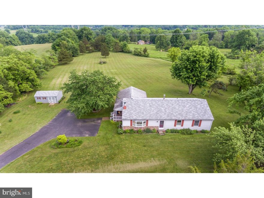 Down a long driveway, this ranch home with almost 2 acres is nestled on a quiet country road with a few minutes' walk to the charming village of Carversville.  The home has been meticulously maintained since 1977 and features solid hickory hardwood floors, solid wood interior doors and a beautiful kitchen with cherry cabinets, granite counters, a center island, stainless steel appliances, and a large bay window that looks out to the rear yard. The 12x24 covered porch with easy maintenance decking, enables ease of indoor-outdoor entertaining.  Large living room with bay window and a stone fireplace that is now propane but can be converted back to wood-burning.  Four nice-sized bedrooms and a hall bath with tile flooring and Corian vanity complete the home.  The master bedroom has a large walk-in closet that backs up to the hall bath, so a master bathroom can easily be added.  The full basement is unfinished and has Bilco door access to the rear yard.  The roof was replaced in 2013 and the central air conditioning system is one-year old.  This is a great home for anyone and is in close proximity to New Hope and Doylestown for restaurants, shopping and museums. Low maintenance, low taxes and low expenses.  This home could be yours!