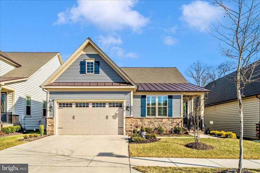 Experience the ease of one-level living without compromising on luxury at 2821 Camomile Dr E, located in the highly desirable Woodlands of Urbana, a vibrant 55+ community filled with exceptional amenities. Built in 2023, this nearly new and popular Albright model offers 2,762 square feet of beautifully designed living space, including 3 bedrooms and 3 full baths.

The main level showcases handsome luxury vinyl plank flooring and plantation shutters throughout. Designed with both comfort and style in mind, the open-concept living area features custom details such as shiplap accents, a tray ceiling, and a striking double-sided gas fireplace shared by the great room and the rear screened porch.

The gourmet kitchen is a standout, featuring a large center island with seating, chef-inspired stainless steel appliances, a beautiful backsplash, and gorgeous quartz countertops with plenty of space for preparing meals and entertaining family and friends.

The spacious primary suite offers two walk-in closets and a spa-inspired bath with a double-sink vanity, tiled shower, water closet, and linen closet. A second bedroom, full hall bath, convenient mudroom, and laundry area complete the main level.

The finished lower level expands the living space with a generous recreation room ideal for billiards, media, crafts and hobbies, exercise, or whatever suits your lifestyle. This level also includes a third bedroom, a full bath, and abundant storage space.

Additional highlights include a two-car garage with an epoxy-coated floor, a screened rear porch for relaxing or entertaining, an open deck for grilling, and a private yard that backs to trees.

Residents enjoy low-maintenance living with lawn care and snow removal, along with outstanding community amenities such as a clubhouse, fitness center, swimming pool, and scenic walking paths. Conveniently located near shopping, dining, medical care, and major commuter routes including I-70 and I-270.