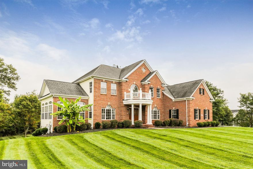 This stately 5 bedroom brick colonial offers it all. The main floor boasts a two-story foyer, living room, formal dining room with tray ceiling and decorative molding, a bright sunroom, a main-level bedroom or office with a full bathroom. The large gourmet kitchen has a center island, stainless steel appliances, and opens to the sun-drenched breakfast room. The grand sunken family room is enhanced by a gas fireplace, a wall of windows, and soaring ceilings. Second level living offers a primary bedroom with sitting room, gas fireplace, a huge private en-suite patio, luxury private bath with soaking tub, shower with dual shower heads and a huge walk-in closet. This level also has three additional bedrooms, one with a full bath and the other two share a Jack and Jill bathroom. The lower level has a recreation room, a wet bar and features a home theater. The two tier composite deck and sprawling stone patio provide the perfect place to gather to tell stories, relax or entertain. The property has beautiful landscaping, hardscape, and a 3-car garage. The amenities are endless!