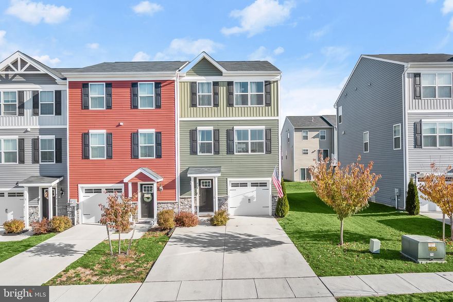 Welcome to this fantastic end-unit townhome in Meade’s Crossing, offering three bedrooms with two full and one half bathrooms. The main level showcases an open concept design with spacious living and dining areas. Prepare your favorite meals in the eat-in kitchen that boasts granite countertops, stainless steel appliances, island with breakfast bar, and pantry. A half bathroom finishes this level. Upstairs, the primary bedroom suite features a walk-in closet and a private bathroom. Two additional bedrooms, a second full bathroom and a convenient laundry room complete the upper level. The lower level includes a foyer with access to the garage. Additionally, there is an unfinished room with sliding glass doors to the rear yard, making this a versatile space that awaits your finishing touches. Enjoy the wonderful community amenities including a community center with a fitness room, an outdoor pool, playgrounds, basketball courts, volleyball courts, dog parks, and more!