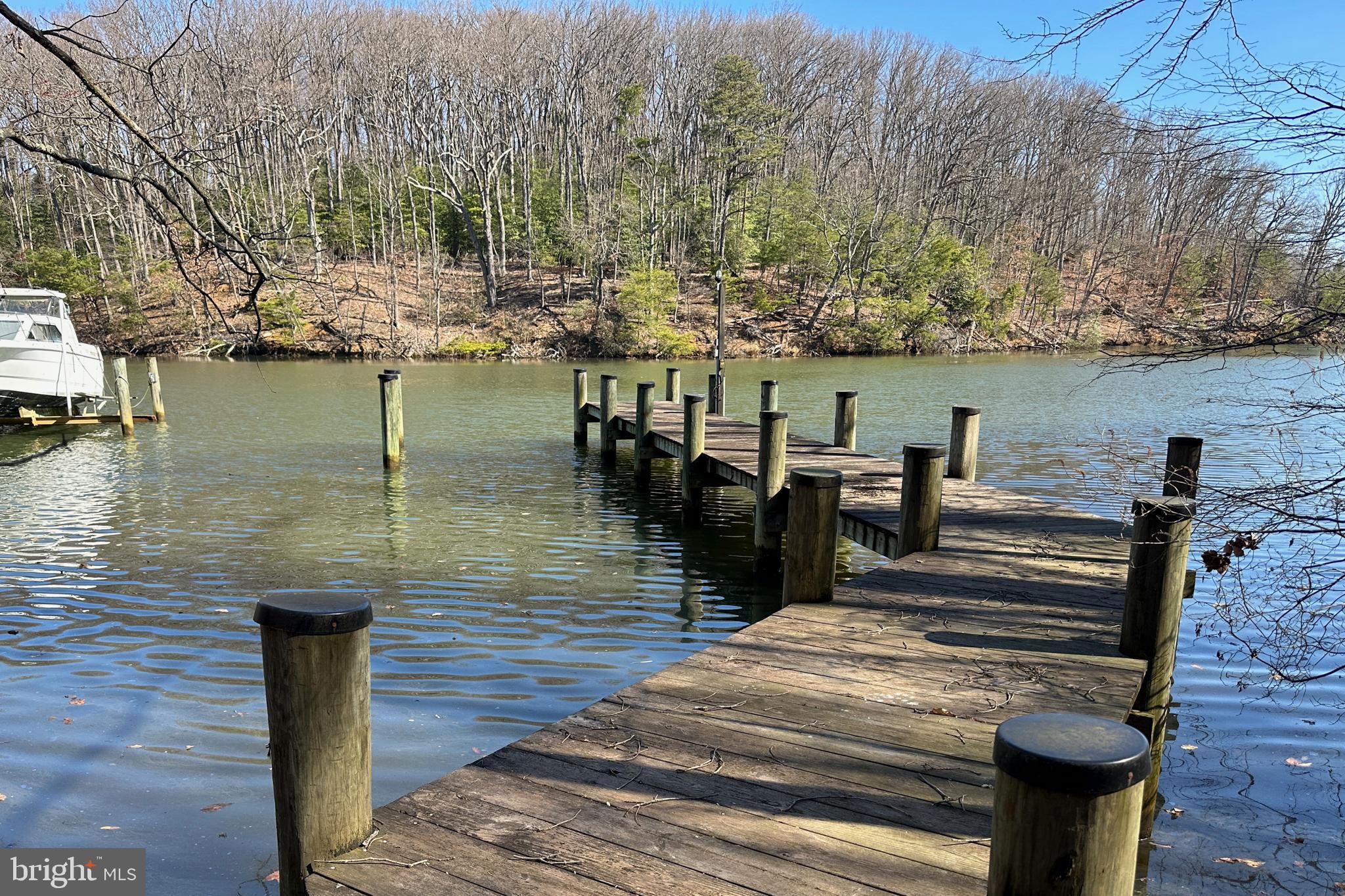 Another $50,000 price improvement!!! Nestled on the banks of Weems Creek off the Severn River, this exceptional waterfront Colonial in Admiral Heights offers 126 feet of private shoreline and deep water access (7-8' MLW) with a newer 80-foot pier perfect for boating enthusiasts. Lovingly maintained by its original owner, this spacious 3-level home features a soaring 2-story living room with a fireplace, a second-floor family room with its own fireplace, and a full walk-out basement ready for your personal touch, complete with a third fireplace and access to a large covered patio, was previously recreation room and fourth bedroom, Enjoy breathtaking water views from the huge main-level deck and second-floor balcony. Located within walking distance of Navy-Marine Corps Stadium and just minutes from downtown Annapolis, this home provides the perfect blend of serene waterfront living and city convenience. Community amenities include a pool, parks, and water access, making this a rare find! Bonus: Room for a 2-car garage. Don’t miss this incredible opportunity—schedule your private tour today! House has so much potential just waiting for your updates!