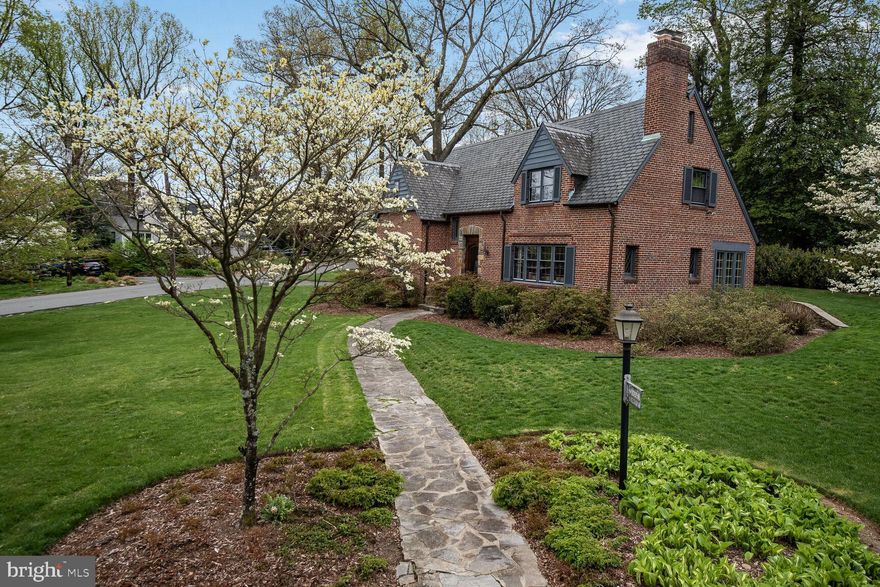 NEW LISTING - Never before available, this very special, custom-designed Tutor home with 8 gables has been lovingly maintained and updated by the same family since it was built!  
Open Sunday, 4/13, from 2 - 4PM

Located in beautiful and convenient Woodside Park, you will be wowed by the presence of this home.  Mature landscaping is beautifully enhanced by the stone walls and flagstone patio off the inviting sunroom.  A new lot line natural hedge is protected from unwanted water run-off by a custom curb.  An underground irrigation system provides drought protection.  The Buckingham slate roof with snowguards and custom copper gutters have been inspected annually.  Downspouts carry run-off water via underground pipes to the street.  A full-house generator provides emergency power.  Plentiful driveway parking, provides easy access to the attached garage, and inside access to the home.

Inside, you will love the bright rooms with loads of great features, including fantastic period woodwork, an amazing, curved staircase, large formal rooms, multiple closets and hardwood floors throughout. 

The main level is flooded with sunshine by large windows in the living room and dining room. An enclosed porch with a beautiful slate floor, invites natural light.  It also features a bedroom suite with a recently upgraded full bath.  The updated kitchen has custom cabinets, countertop lighting, gas cooktop with down-draft exhaust fan, wall oven and microwave, Sub-Zero fridge, Miele dishwasher, plus a charming breakfast nook and spacious pantry.  Don't miss the useful laundry chute, accessible from both the kitchen and 2nd floor to the basement laundry room.  Interior access to the attached garage is via an enclosed alcove from the kitchen.  

Upstairs, you’ll find 3 nicely sized bedrooms, and 2 full baths (one is en-suite for the primary bedroom).  One bedroom has a walk-in closet, which provides access to a very spacious walk-in Cedar closet plus the hand laundry chute.  A bonus room provides the perfect space for an office or a nursery. 

The tiled lower level features a main room with a closet and a naturally cooled wine closet, a very spacious laundry room, half-bath, and a potential bedroom and full closet with a hardwood floor.  The enclosed furnace room houses an upgraded gas-fired furnace and gas hot-water heater, storage cabinets and shelving. Cooling is via a separate CAC system.  An automatic whole house generator completes the utility equipment.

This bucolic but close-in Silver Spring neighborhood provides easy access to the Metro, Shops and restaurants, too.