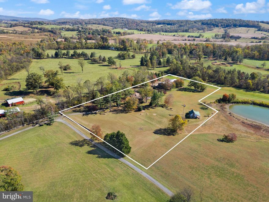 Two purchase options available:

Option 1 includes the home, existing workout building, and a 9,200 sq. ft. building situated on 6.7 acres, offered at $1,370,000. 

Option 2 includes the home, existing workout building, 9,200 sq. ft. building, and a fishing shack on an additional 0.75-acre parcel (7.45 acres total) offered at $1,500,000.

A rare opportunity to own a custom mid-century modern home on a private 6.7-acre setting in Warrenton, VA—complete with a 9,200 sq. ft. conditioned building and a recreational facility: 775 sq. ft. gym/pool house with a full bathroom. This architecturally unique home features vaulted wood-beamed ceilings, walls of glass, and open living spaces that blend beautifully with the natural surroundings. While the home would benefit from some updates, it offers tremendous potential in an exceptional location.

The main level includes a dramatic great room with panoramic views, a floor-to-ceiling brick fireplace, and access to an oversized deck perfect for entertaining or enjoying peaceful sunsets. The open kitchen features natural wood cabinetry and a center island, offering an excellent template for modern upgrades.

The walk-out lower level provides flexible space for recreation, home office use, or guest accommodations. Outside, the property features mature trees, a fenced yard, and an in-ground pool ready for restoration—ideal for creating your own outdoor oasis.

Included on the property is a county-approved 9,200 sq. ft. personal storage/workshop building with a 2nd-floor apartment (1 bedroom, full bath, full kitchen, washer/dryer) plus a 1,350 sq. ft. office/library with full bath and kitchenette. The apartment is approved as a second dwelling (ADU).

Please request surveys and building plans from your agent.