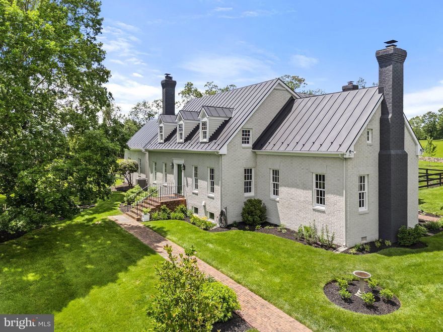 Cross Creek Farm – Purcellville, VA

Nestled between the charming towns of Middleburg and Purcellville, Cross Creek Farm offers a private retreat on a picturesque hilltop with sweeping views in every direction. A scenic private driveway winds through mature woodlands, setting the stage for this serene country escape.

Built in 1986 and meticulously maintained and updated, the home features 4 spacious bedrooms—including a primary suite on either the main or upper level—3 full baths, and a half bath. Warm and inviting interiors boast wood floors, exposed wood beams, three fireplaces, one with a cozy woodstove. The large gourmet kitchen is perfect for entertaining, and a louvered brick terrace provides the ideal spot to enjoy the peaceful surroundings.

The property’s exterior is just as impressive, with restored perimeter stone walls, a fenced backyard, beautifully landscaped gardens, and room for horses. Thoughtful architectural details, fine woodwork, and custom moldings throughout make this a truly one-of-a-kind offering.

Enjoy country living with the convenience of easy access to schools, shopping, and Dulles International Airport.